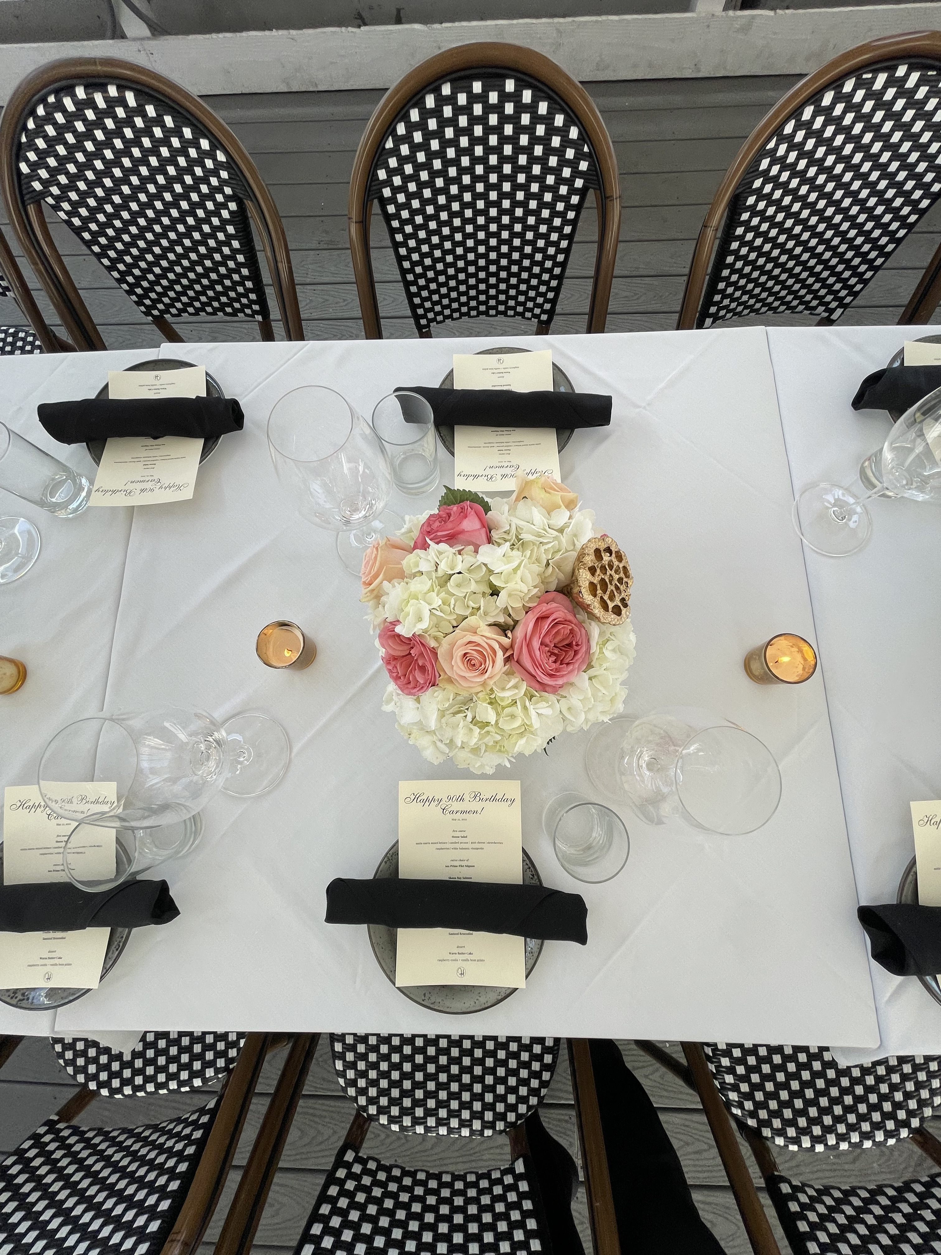 a table with flowers and glasses