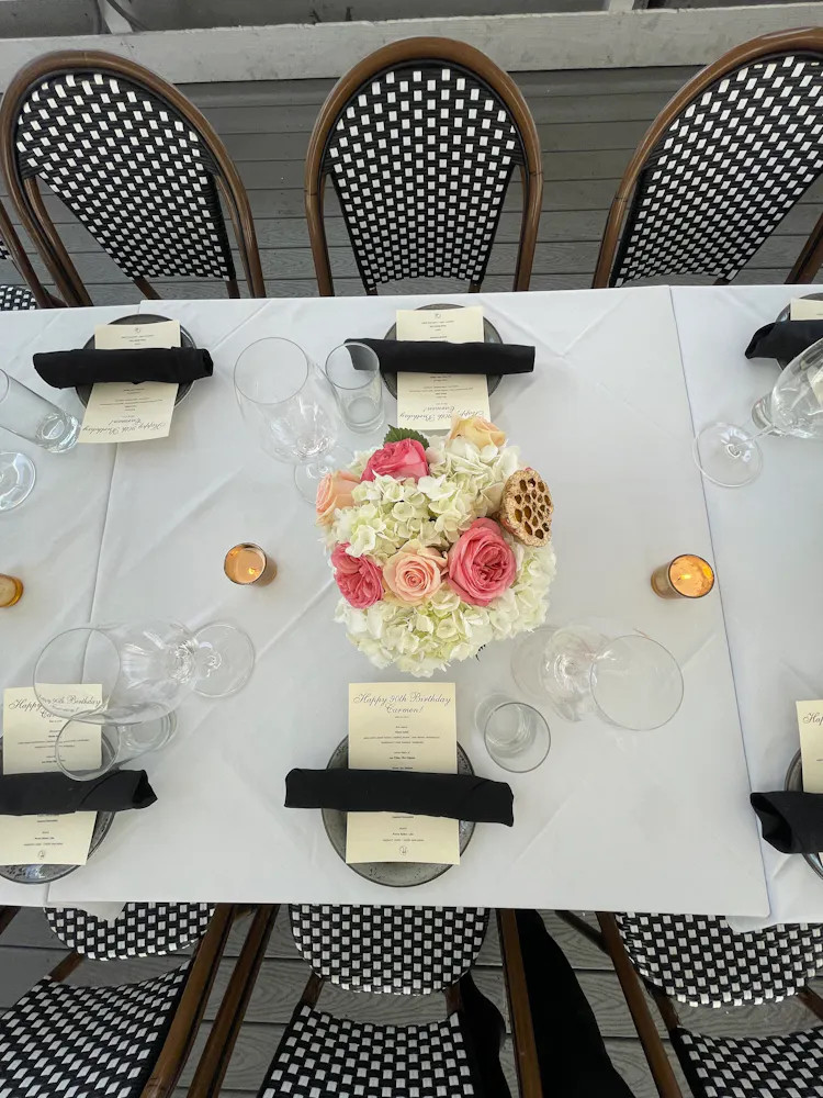 a table with flowers and glasses