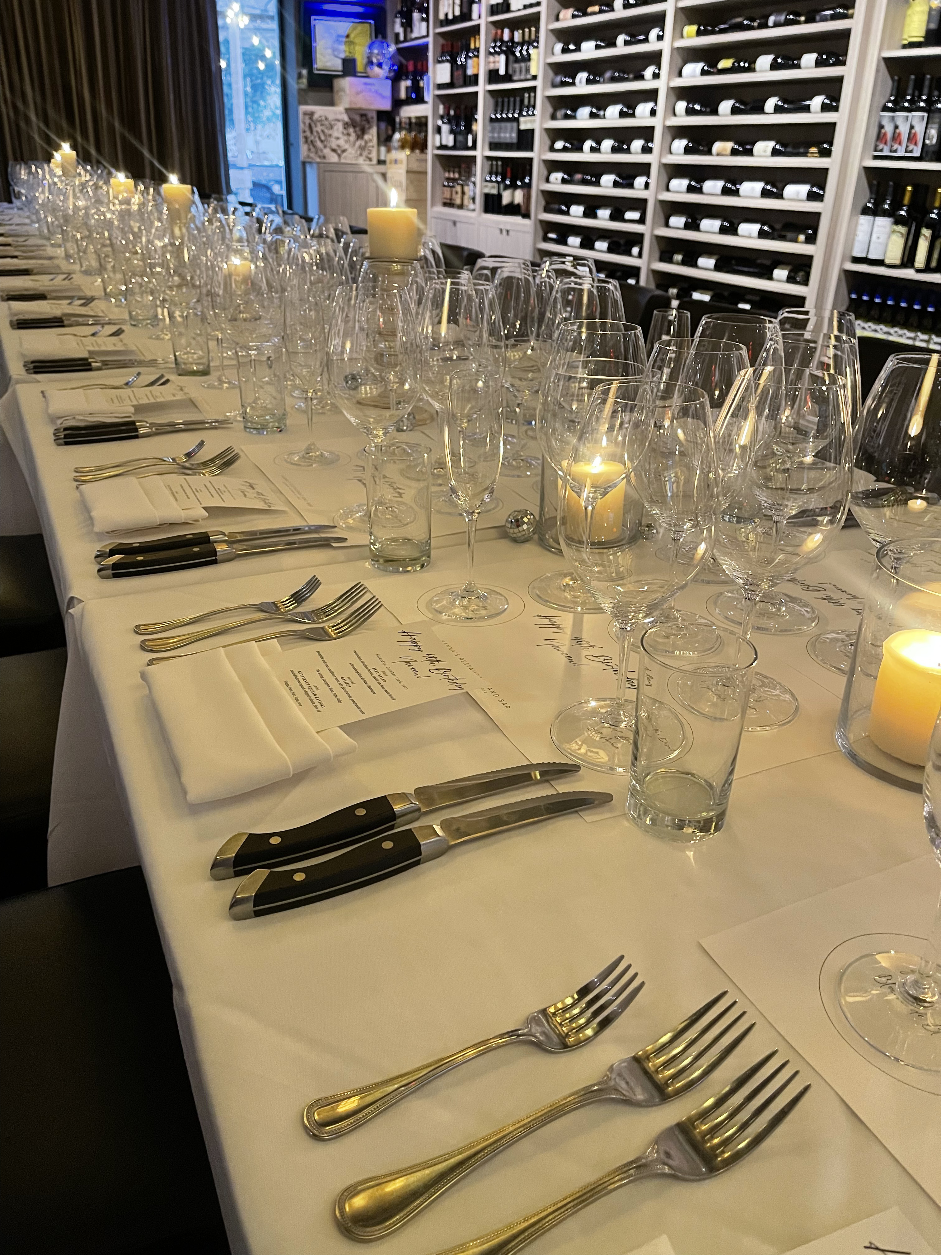 a table with wine glasses and candles