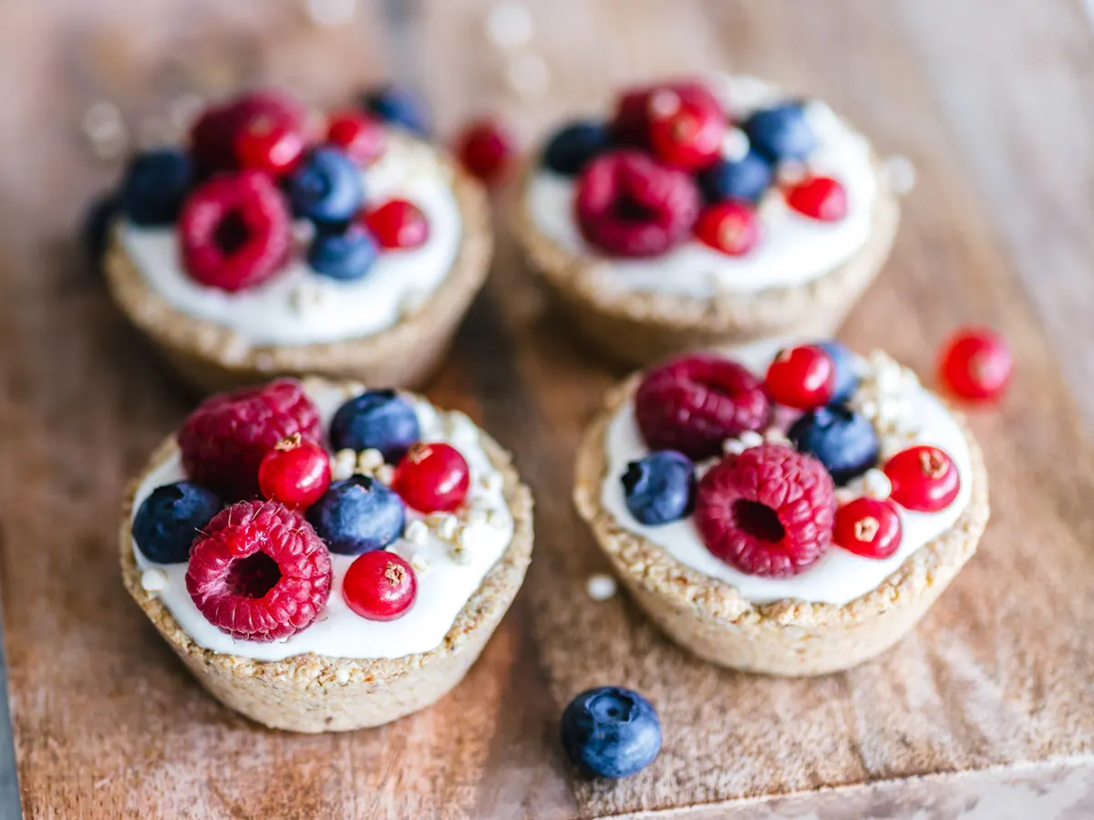 a cake with fruit on top of a wooden table