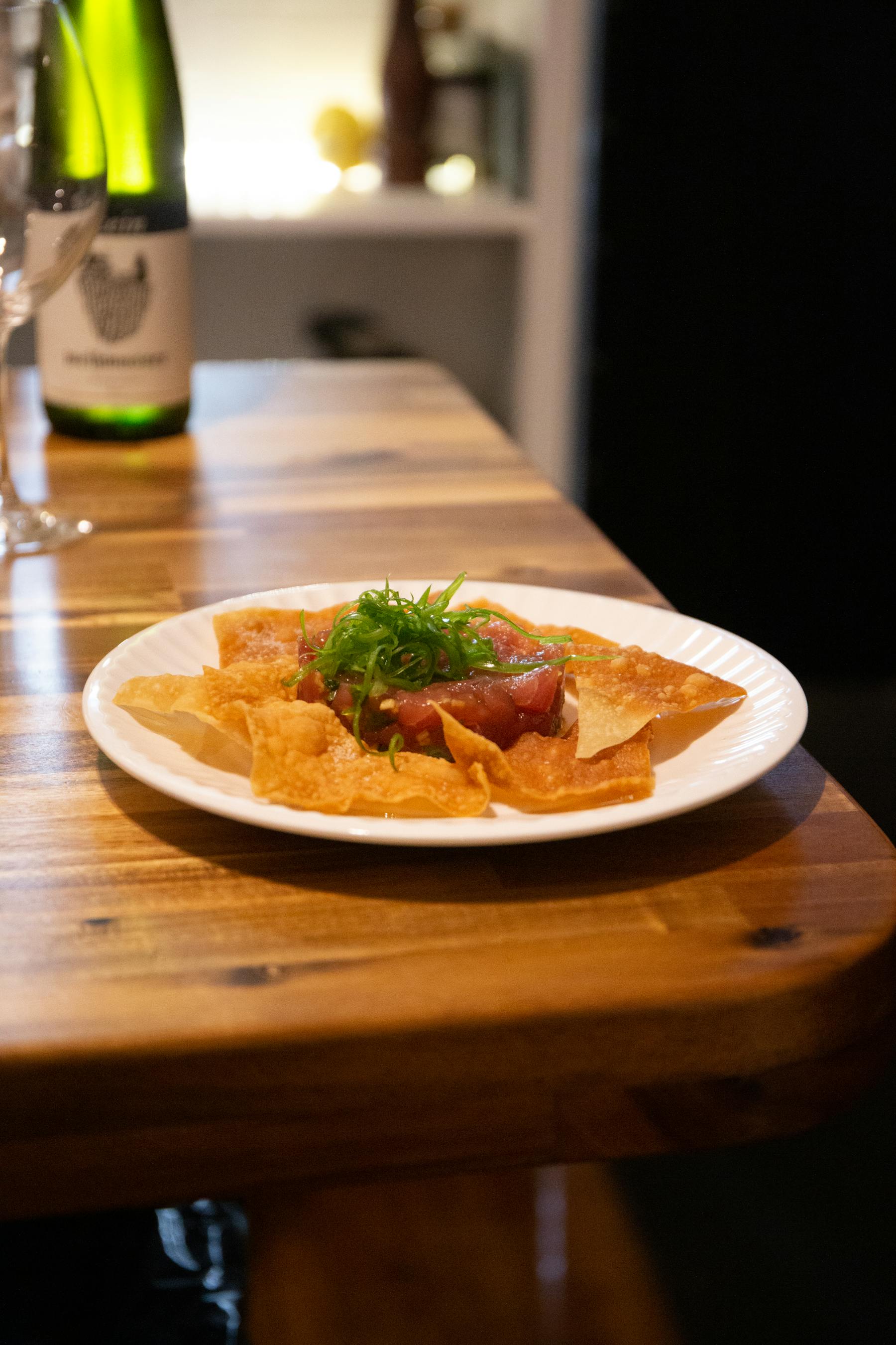 a plate of food sitting on top of a wooden table