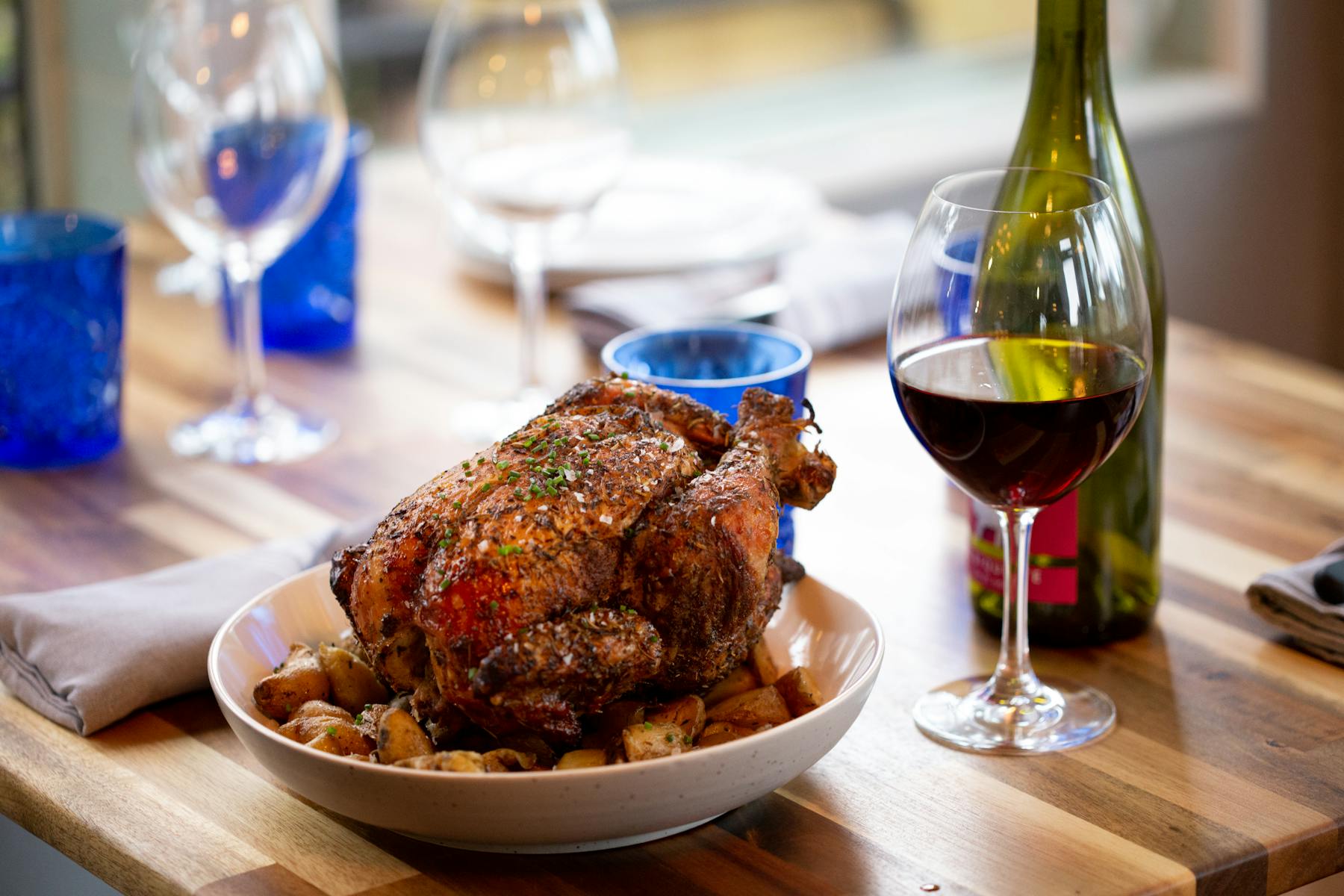 a close up of a plate of food and a glass of wine