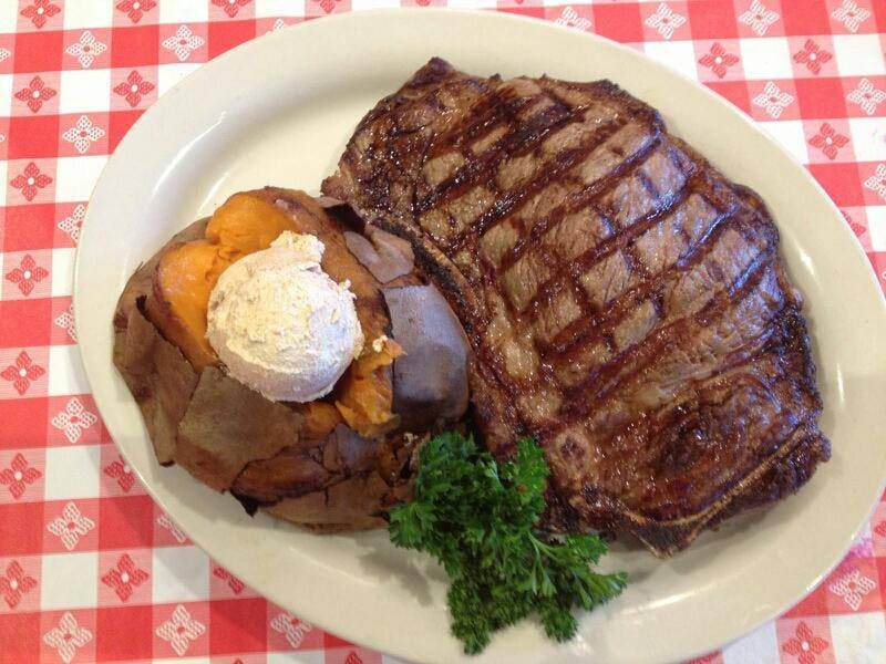a white plate topped with meat and vegetables