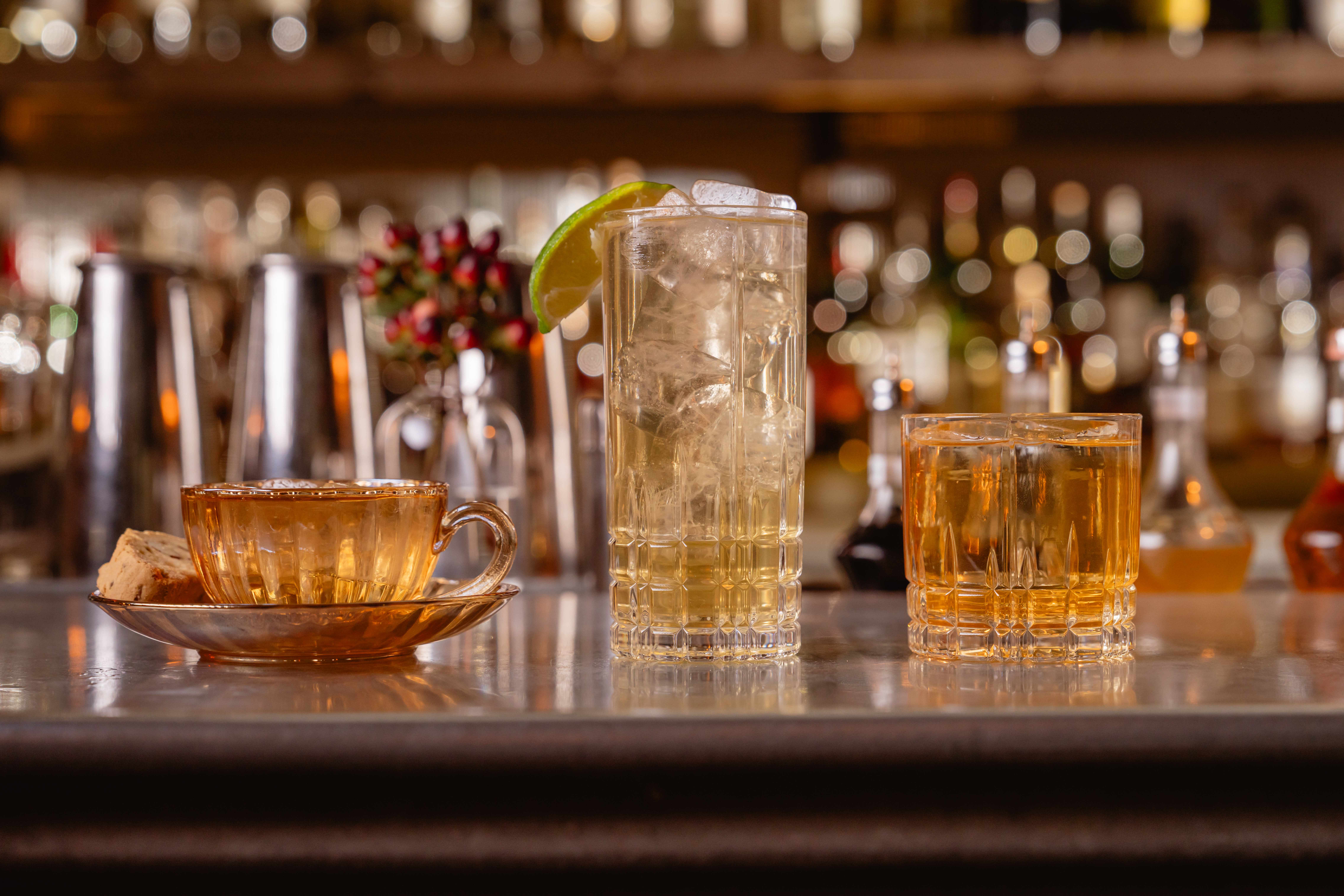 a group of glasses with ice and a lime slice on top of them