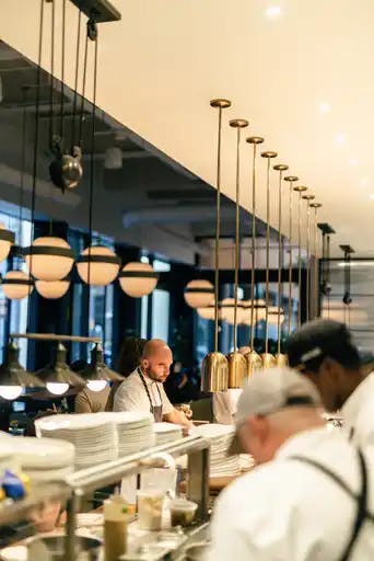 a group of people preparing food in a restaurant