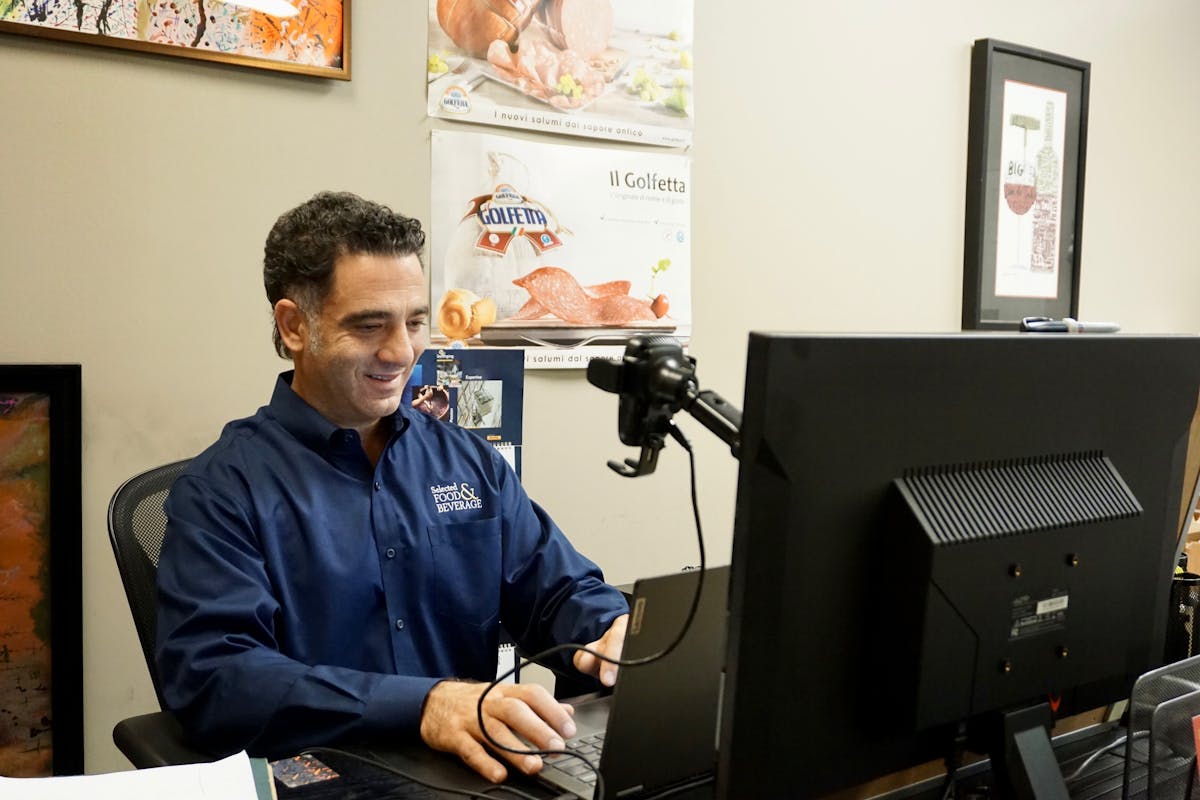 a man sitting at a desk in front of a computer