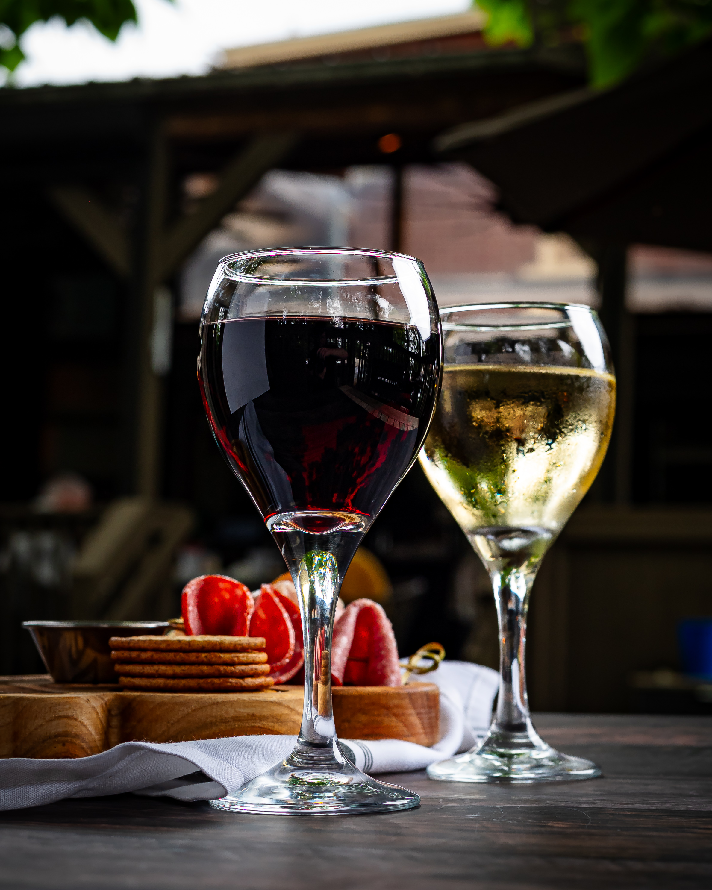 a glass of wine sitting on top of a table