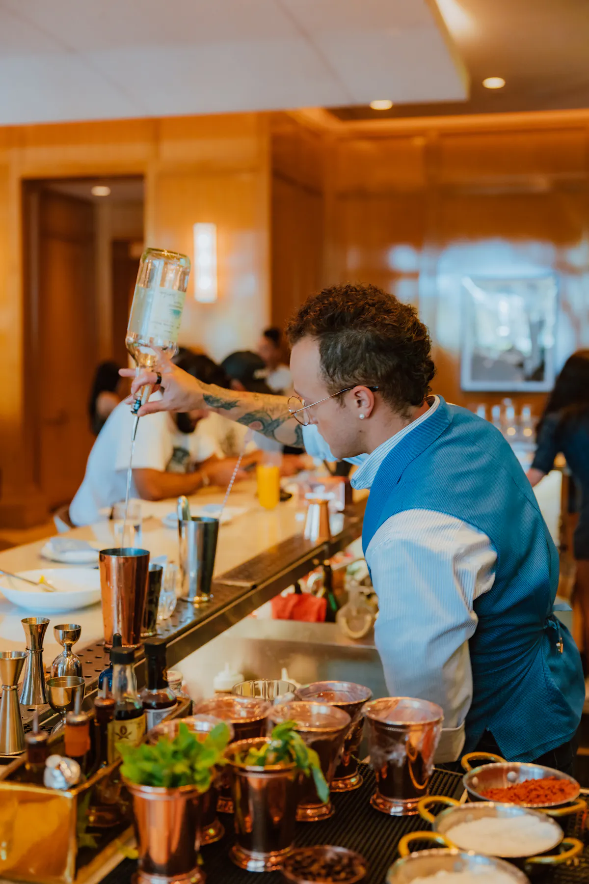 bartender at set steak and sushi pouring drinks