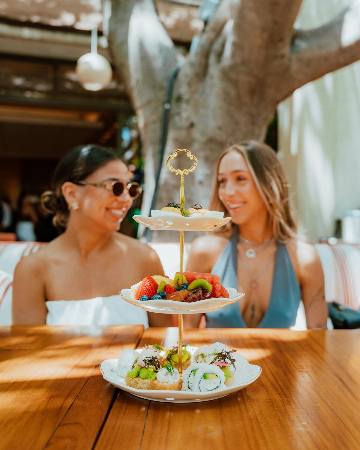 a woman standing in front of a wooden table