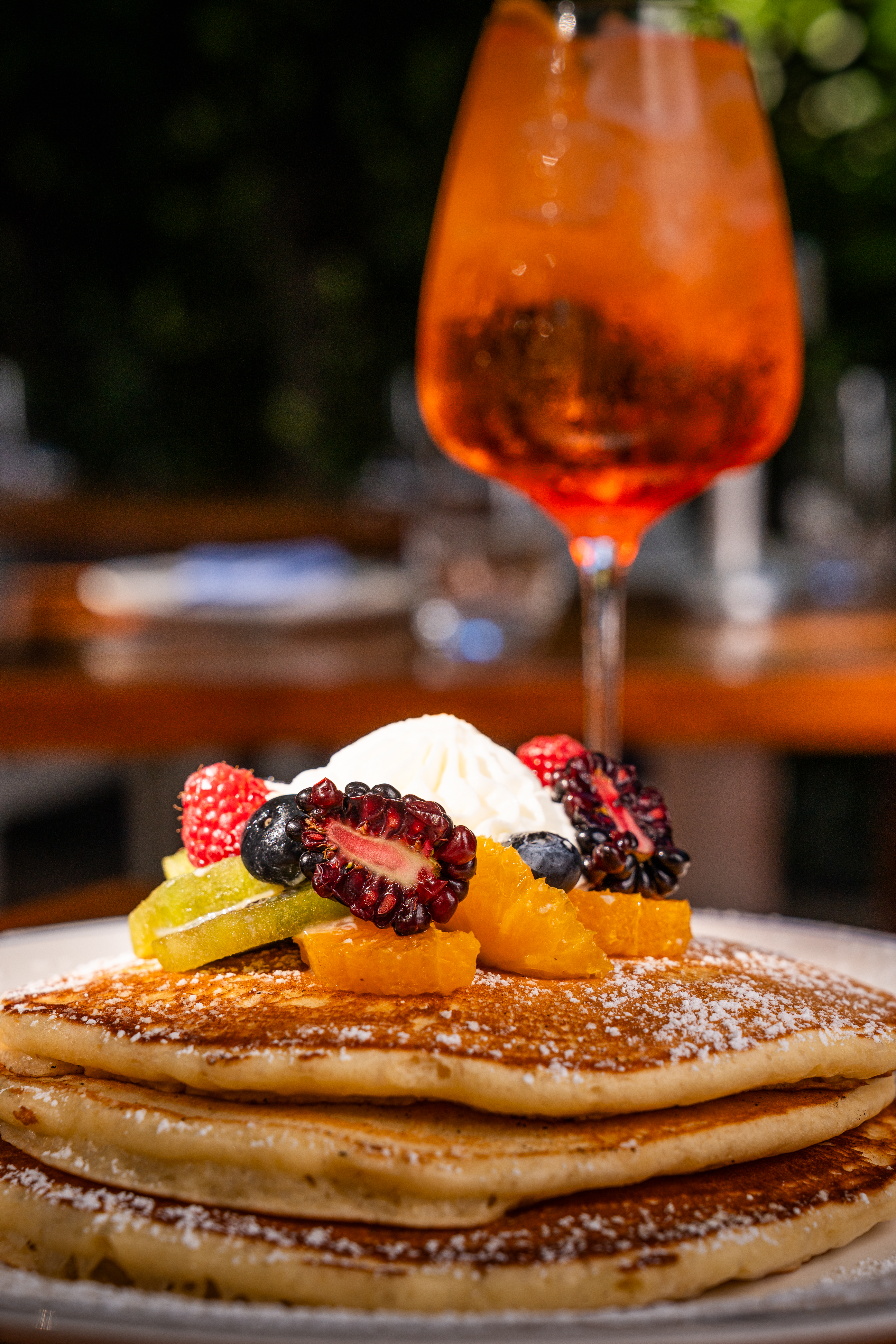 a close up of a plate of food and a glass of wine