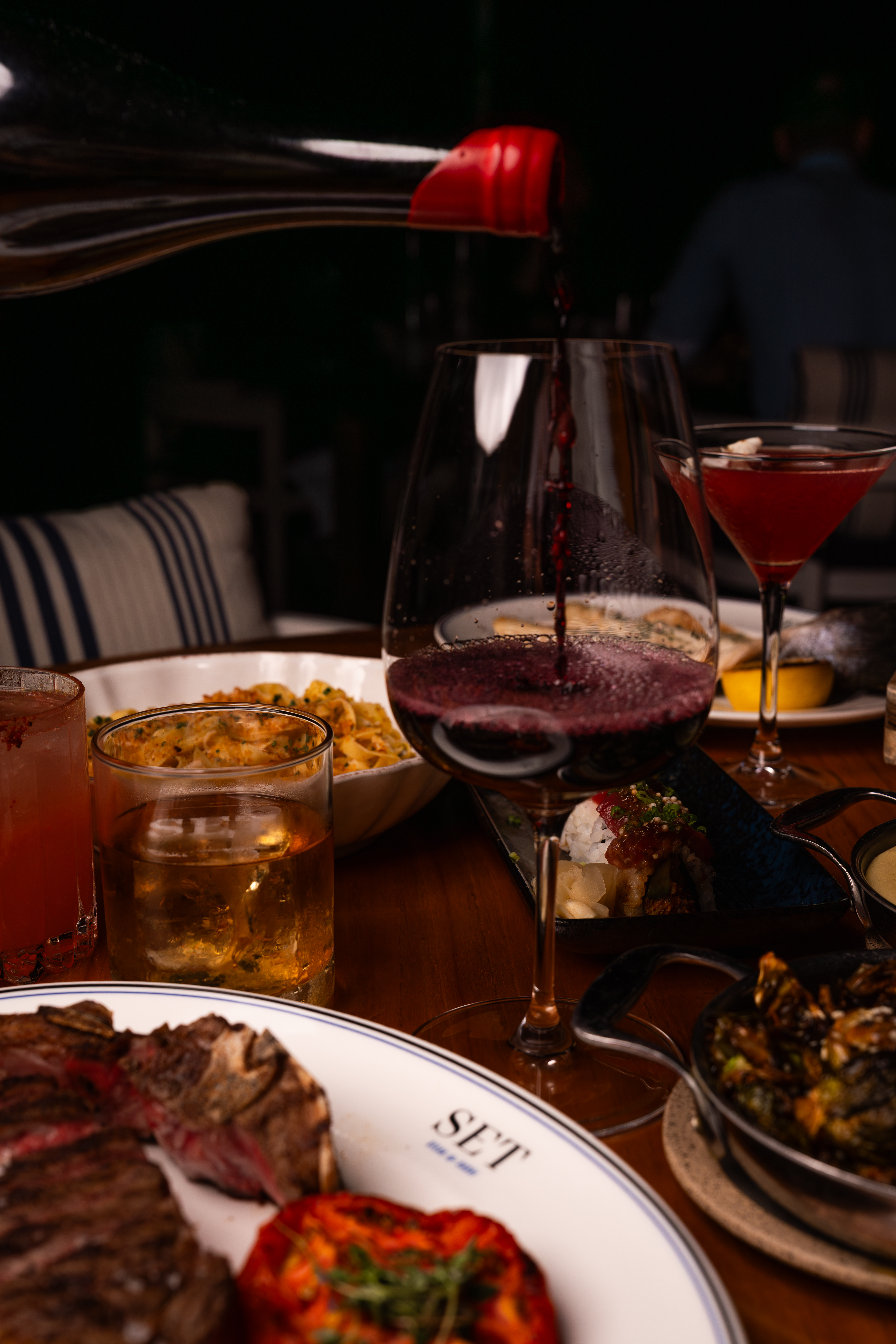 a plate of food and glasses of wine on a table
