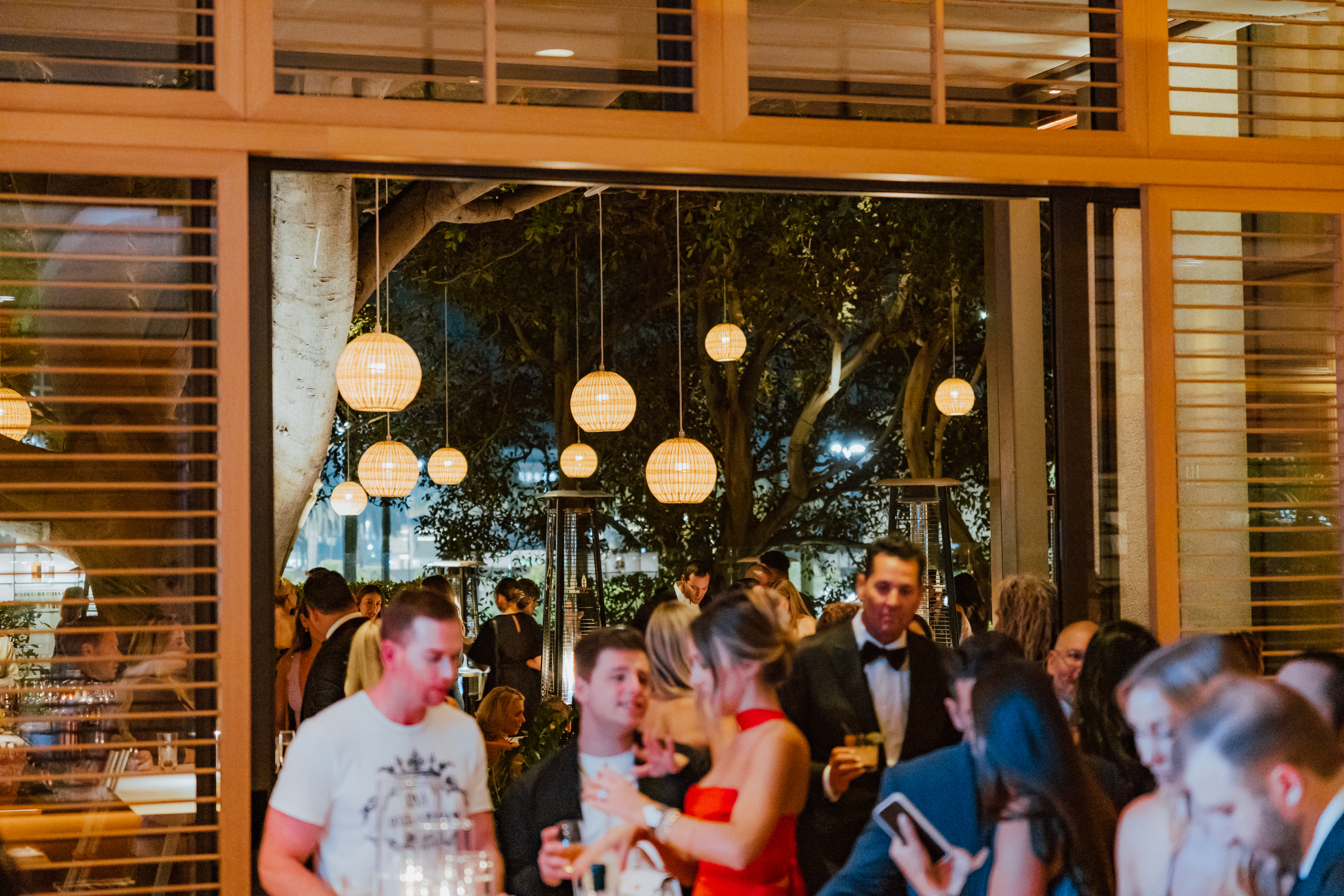 a group of people standing in front of a bar