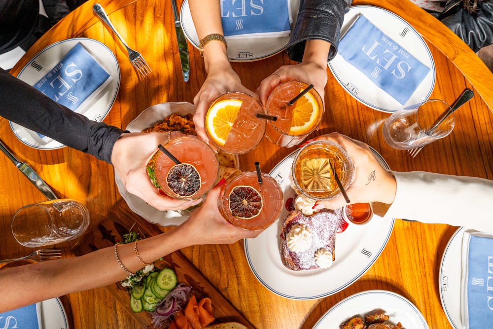 a person sitting at a table with plates of food