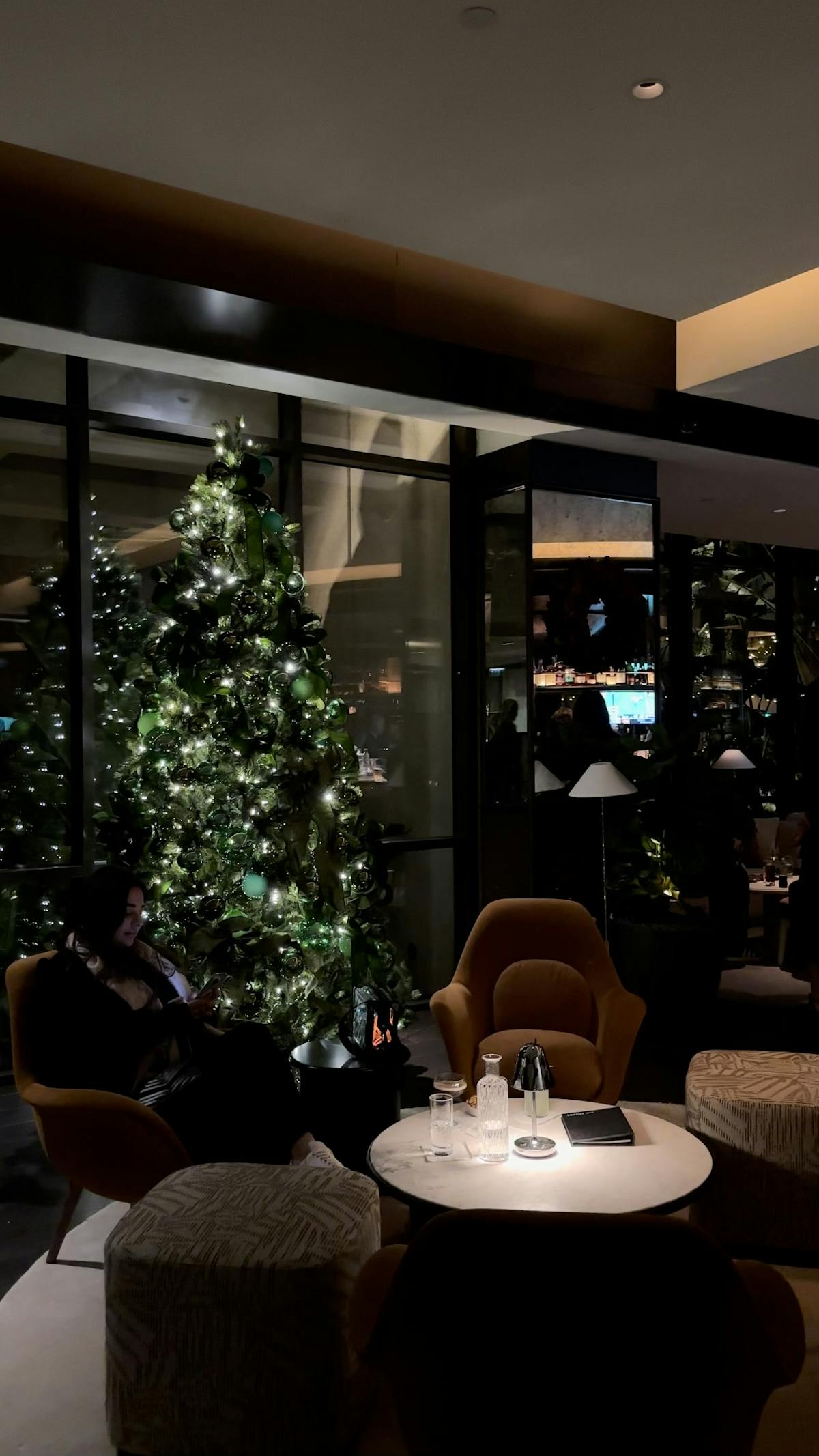a person sitting at a table in front of a window