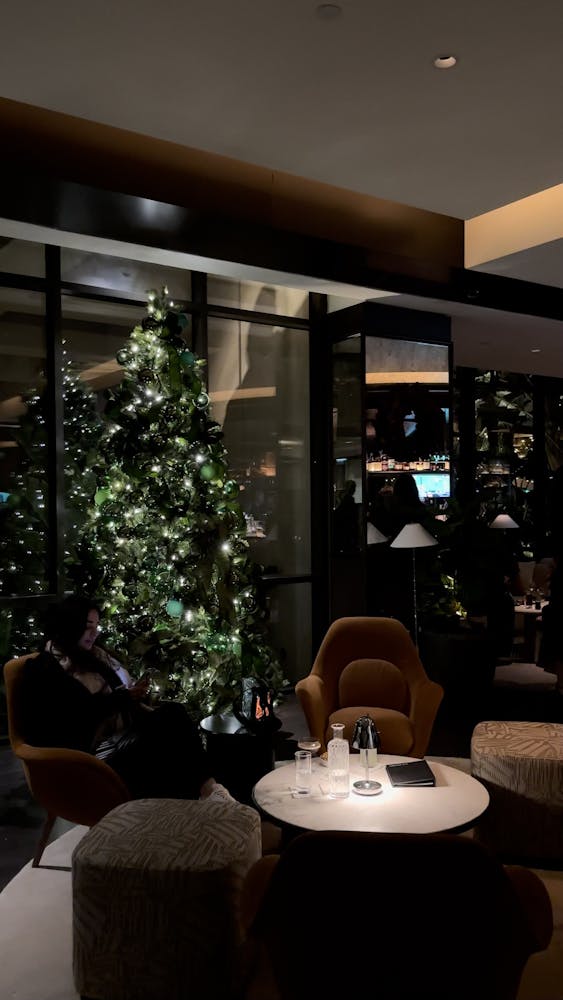 a person sitting at a table in front of a window