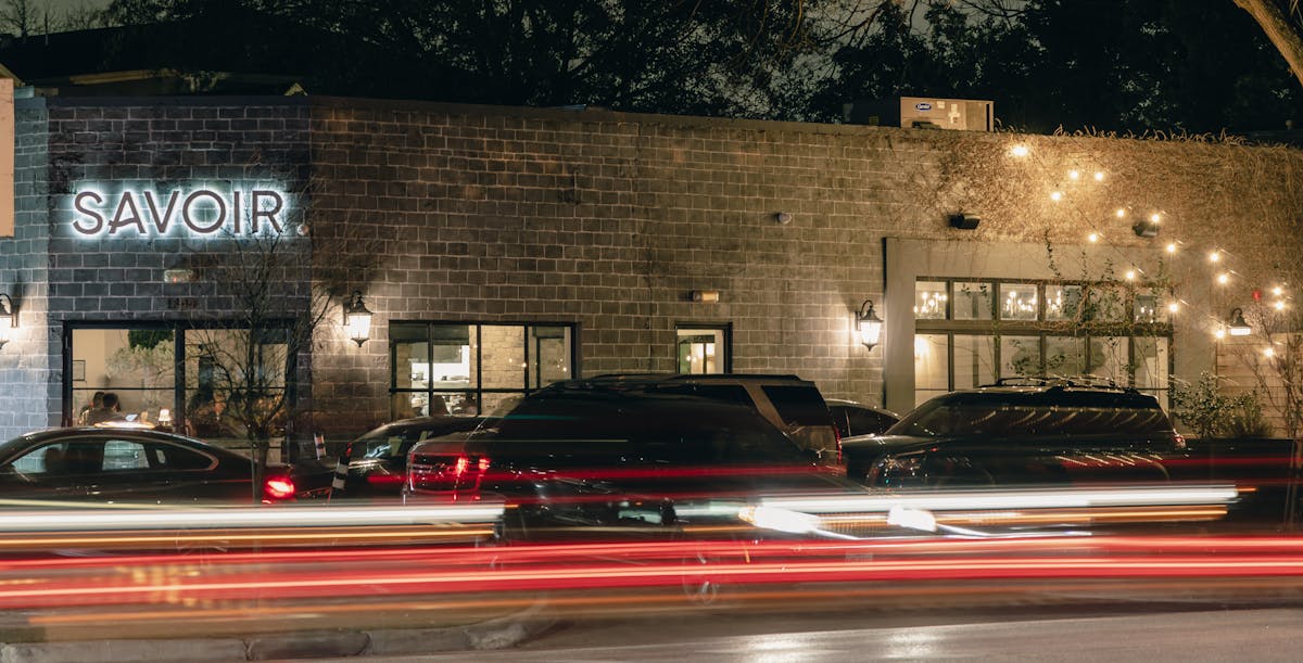 a car driving down a street in front of a building