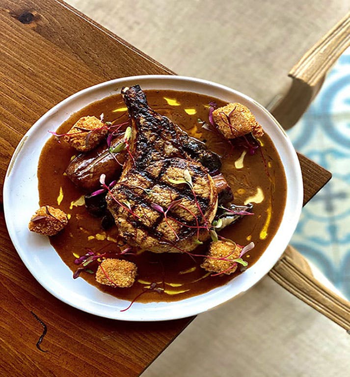 a plate of food sitting on top of a wooden table