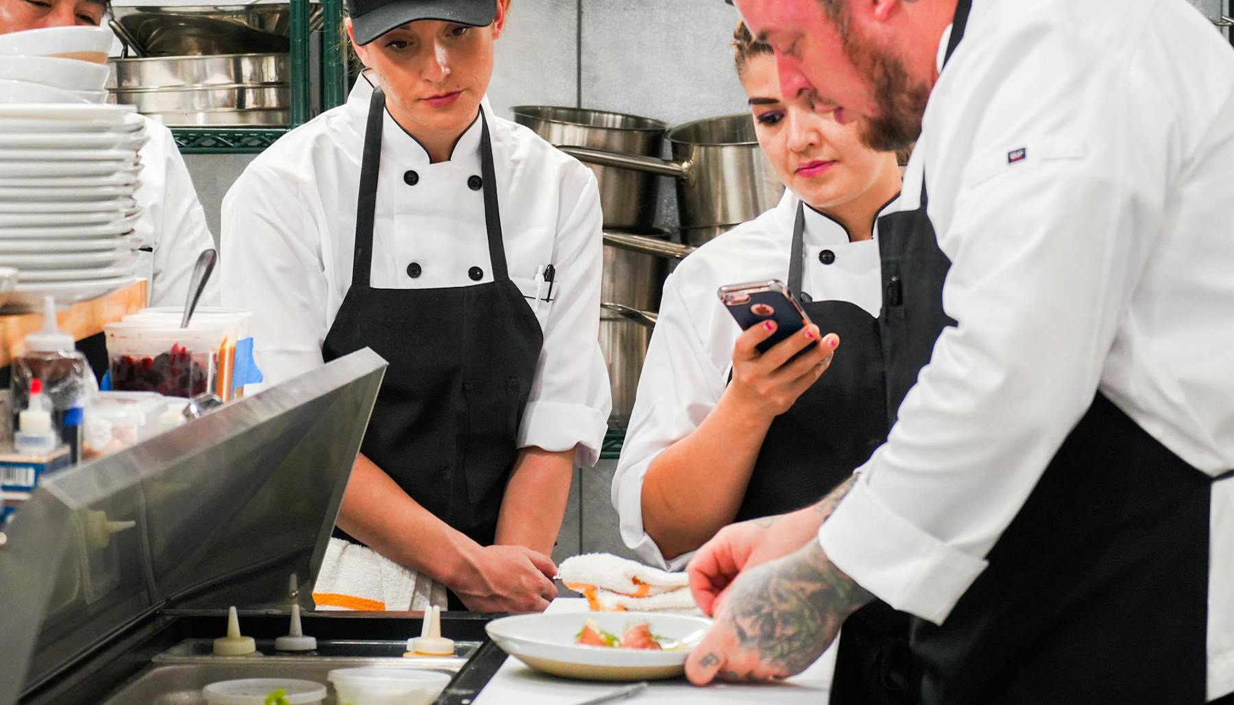 a group of people preparing food on a table