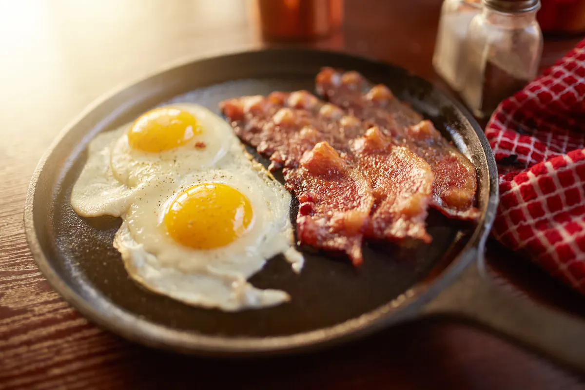 eggs and bacon on a skillet