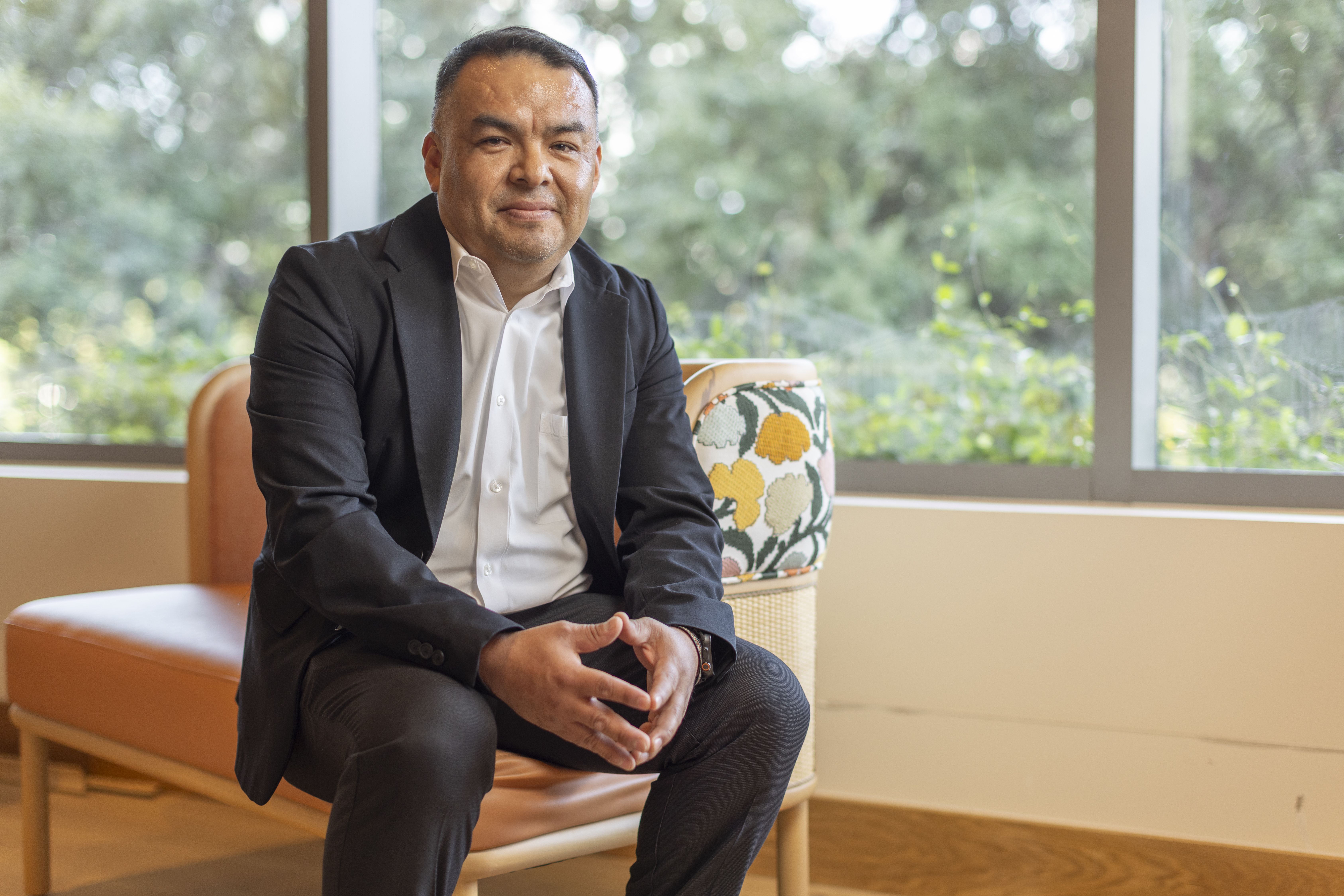 a person sitting on a chair in front of a window