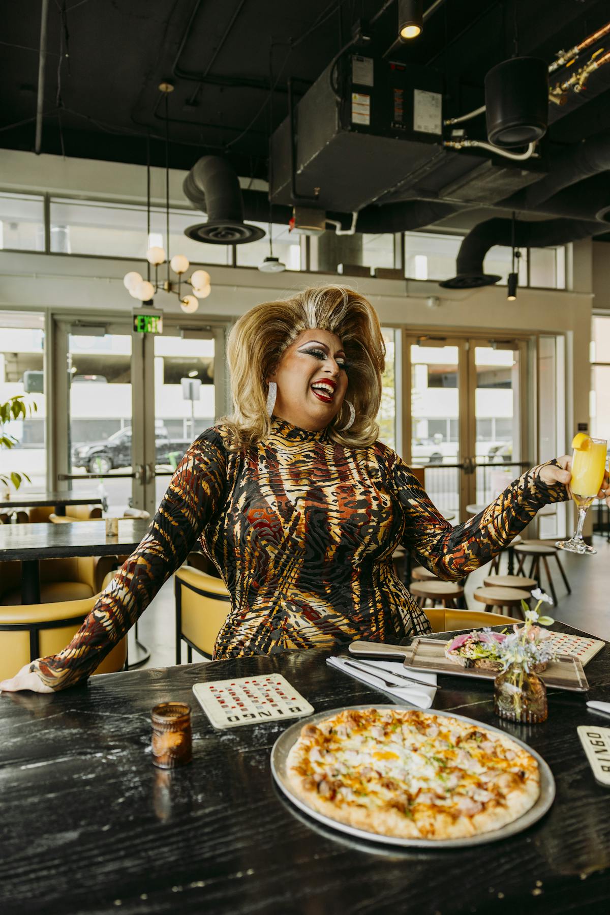 a woman holding a slice of pizza