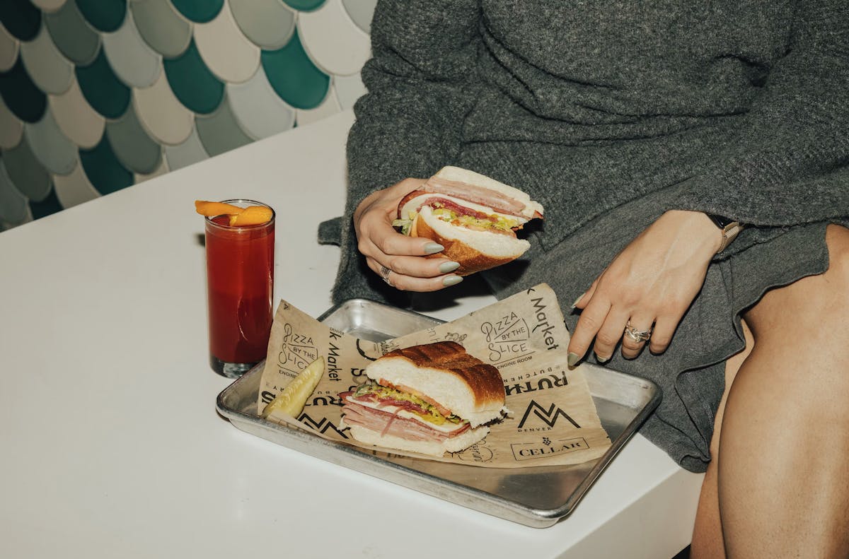 a person sitting at a table with a plate of food