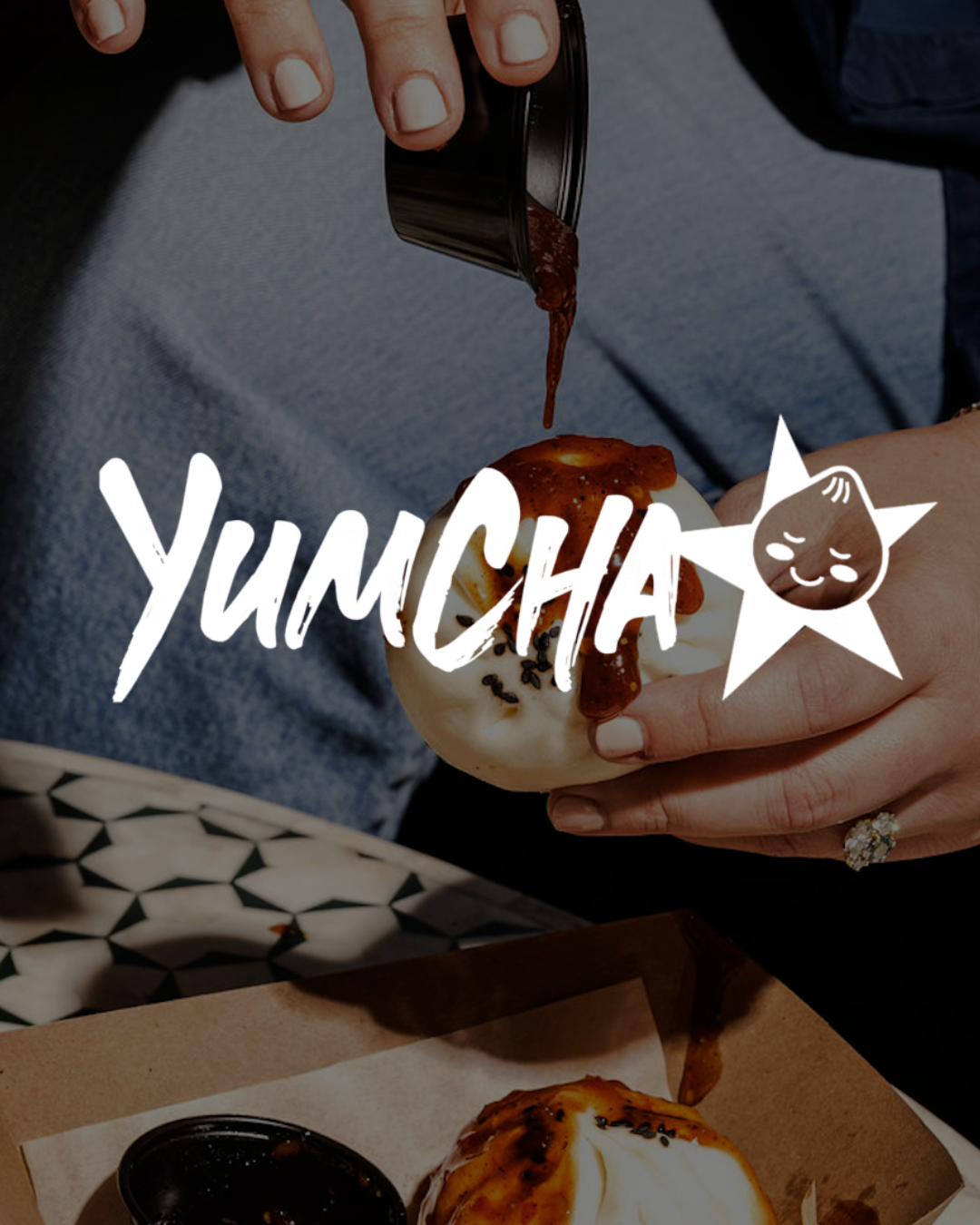 a person pouring sauce on a food