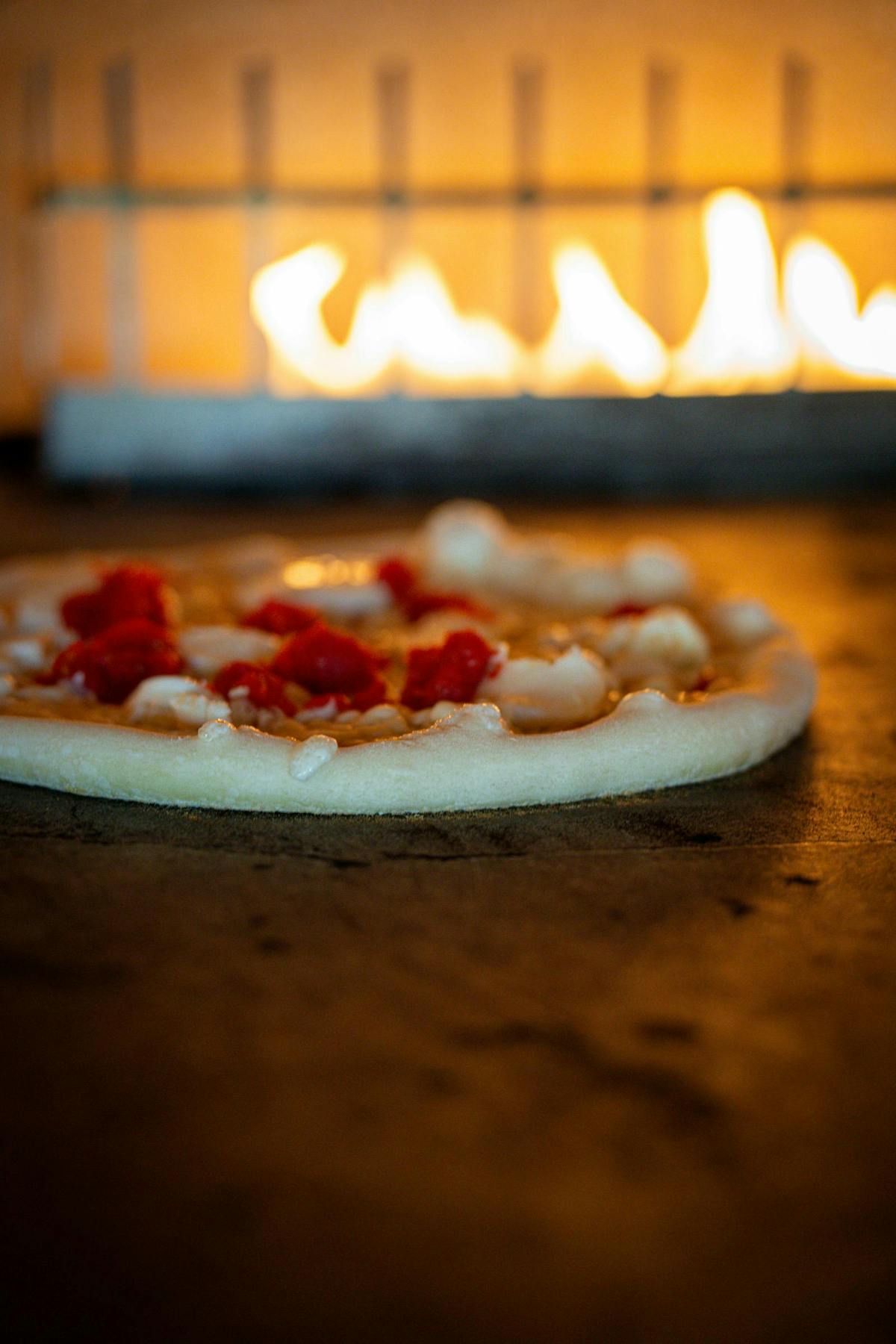 a pizza sitting on top of a wooden table