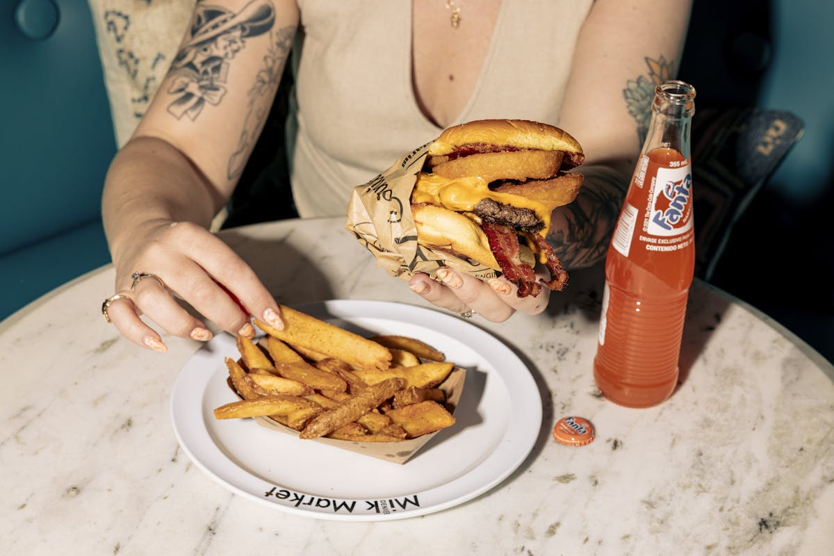 a person sitting at a table with a plate of food