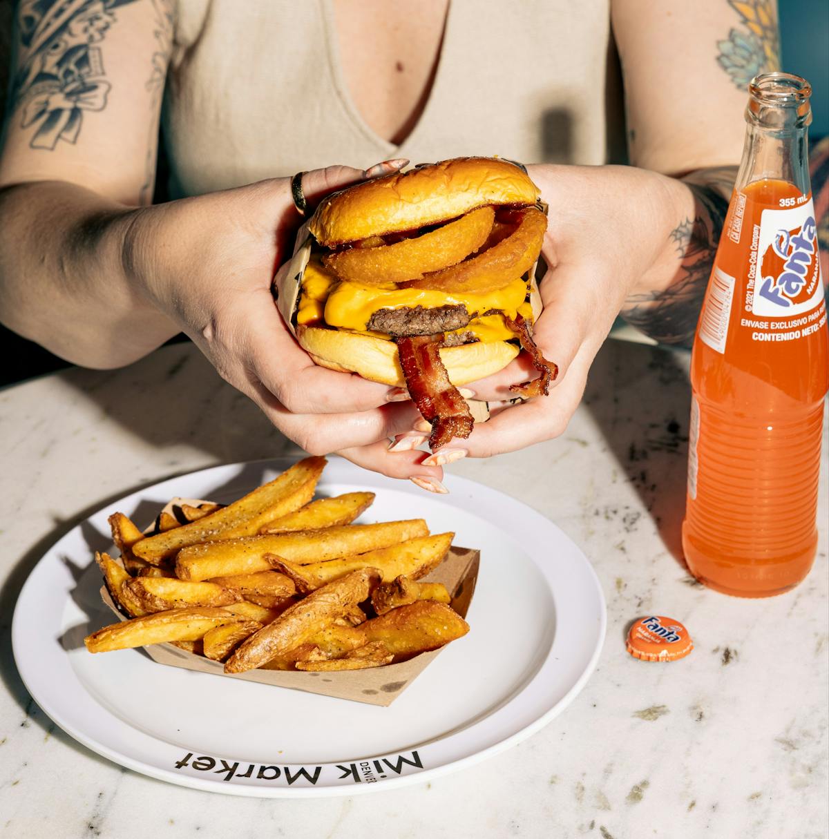 a person sitting at a table with a plate of food