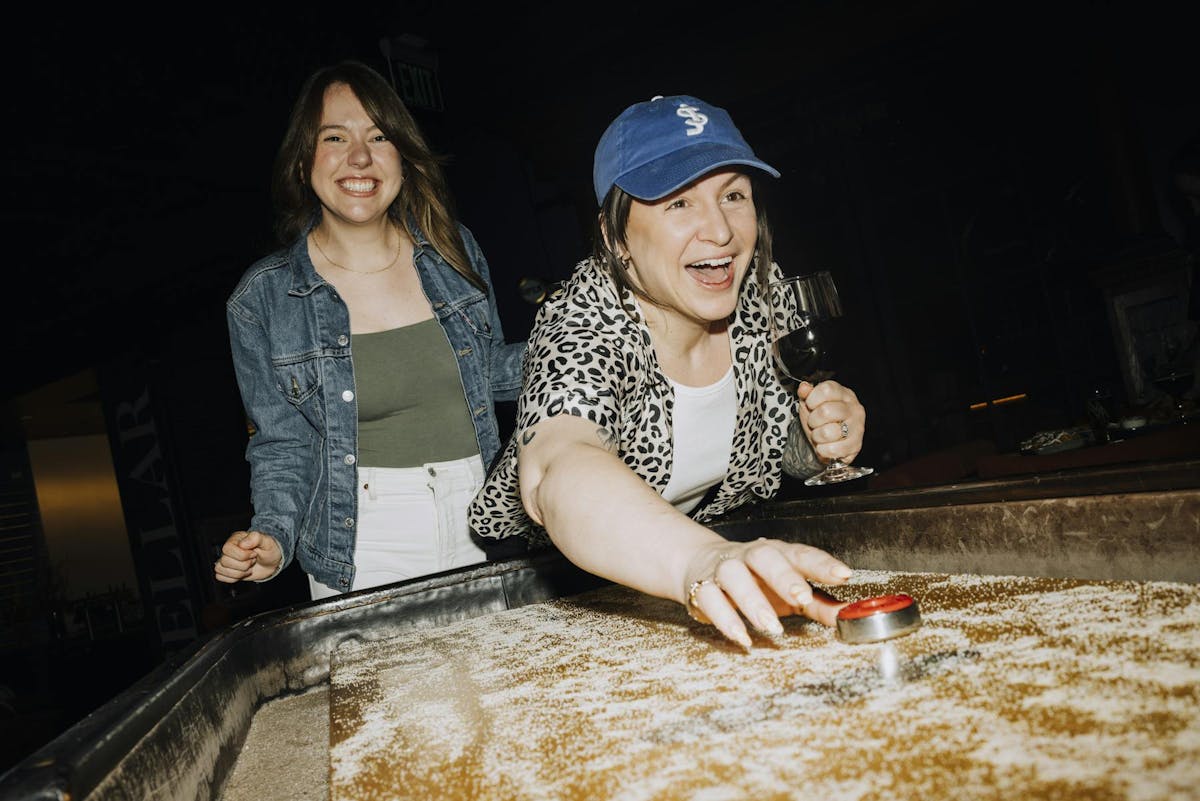 a woman sitting on a cutting board with a cake