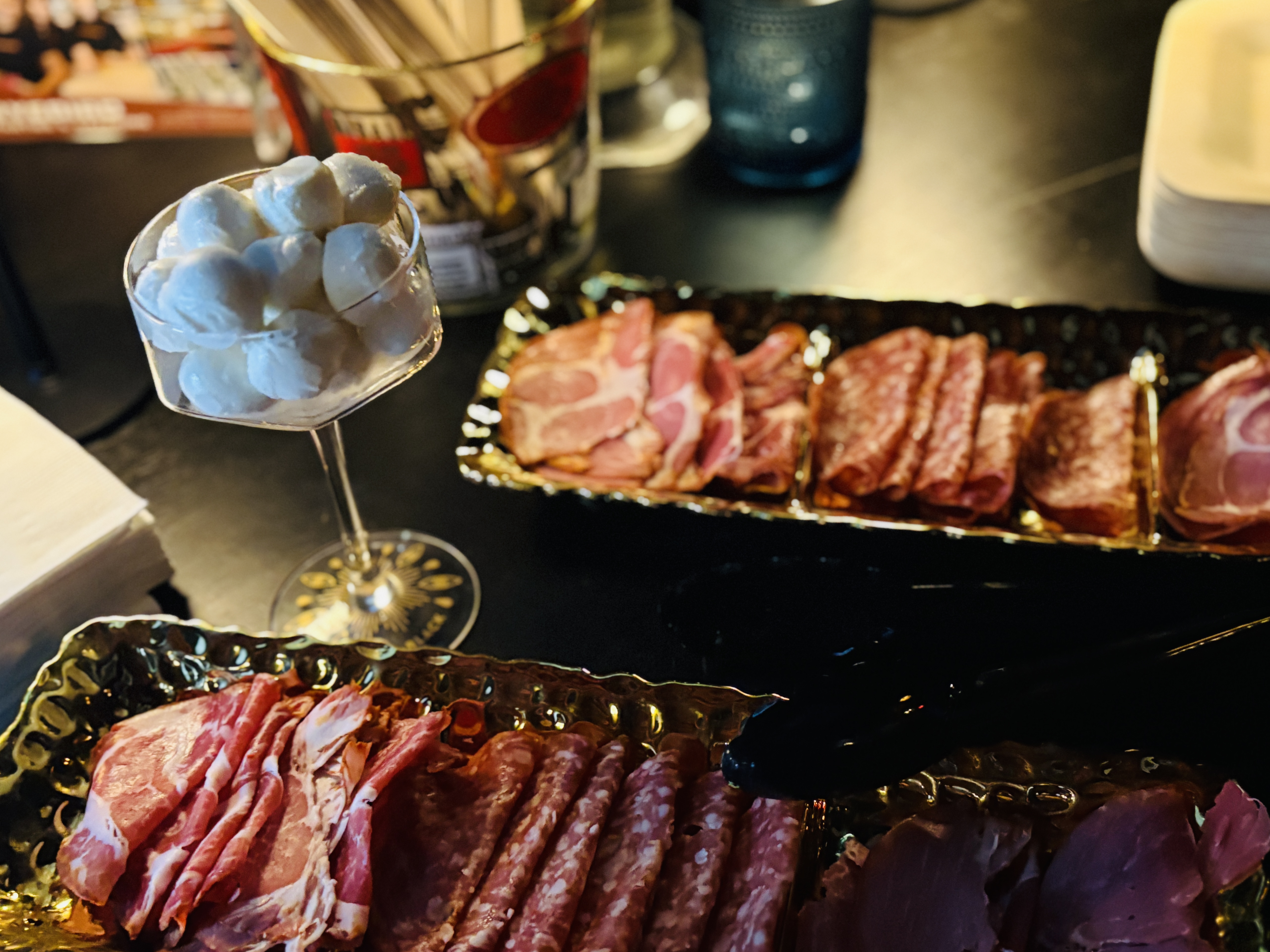 a trays of meat and cheese on a table