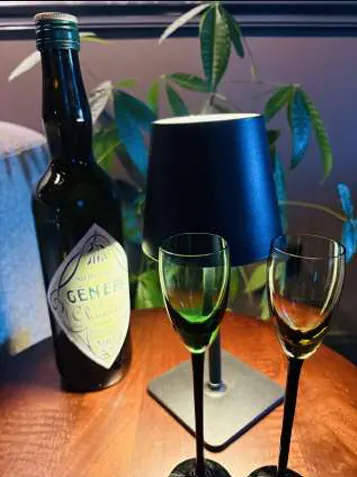 a bottle and glasses on a table