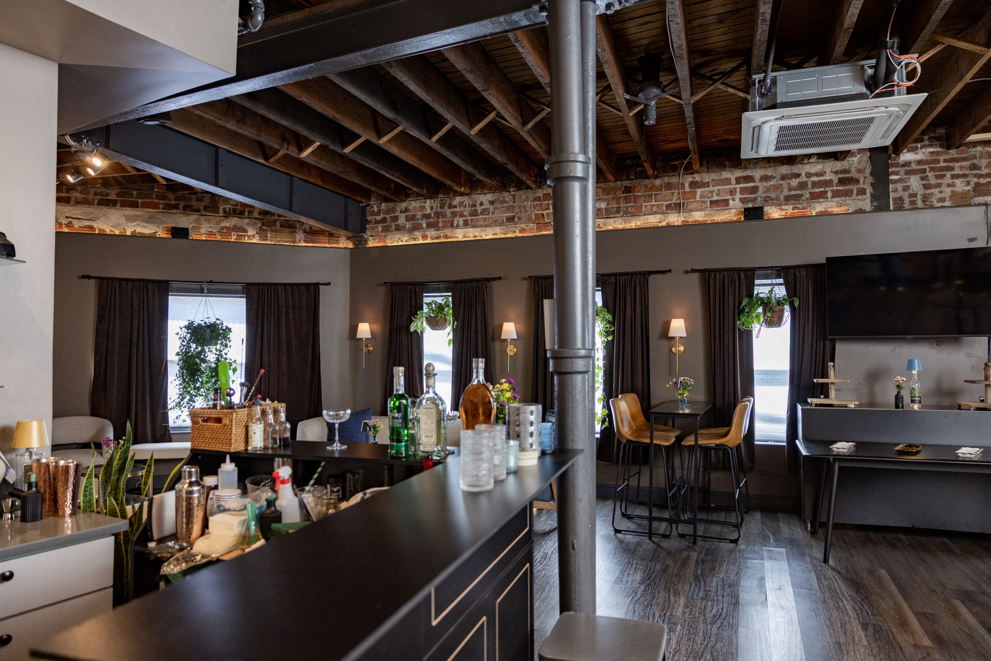 a room with a bar and chairs