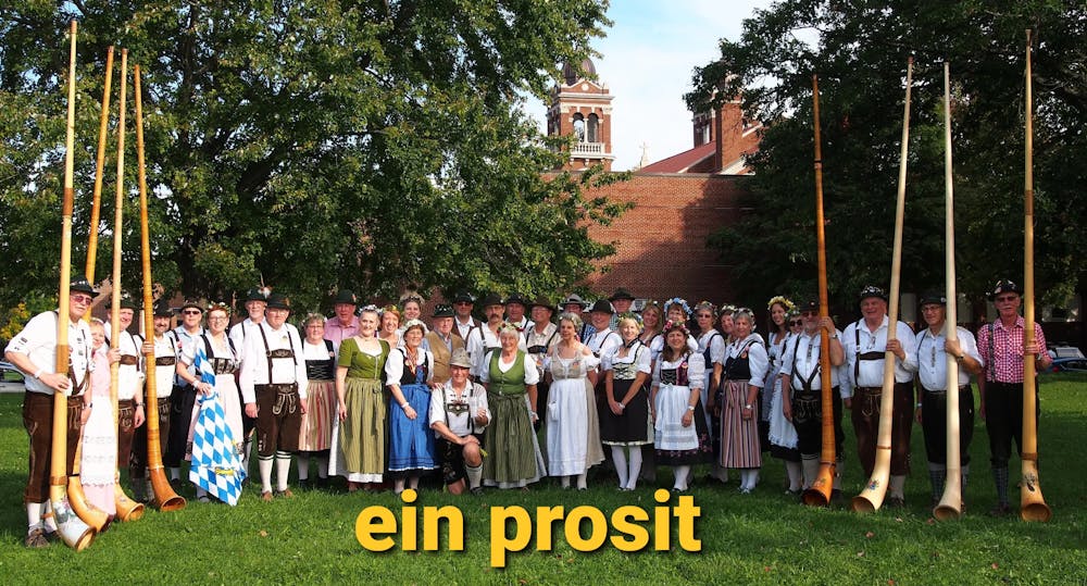 a group of people standing in front of a crowd posing for the camera