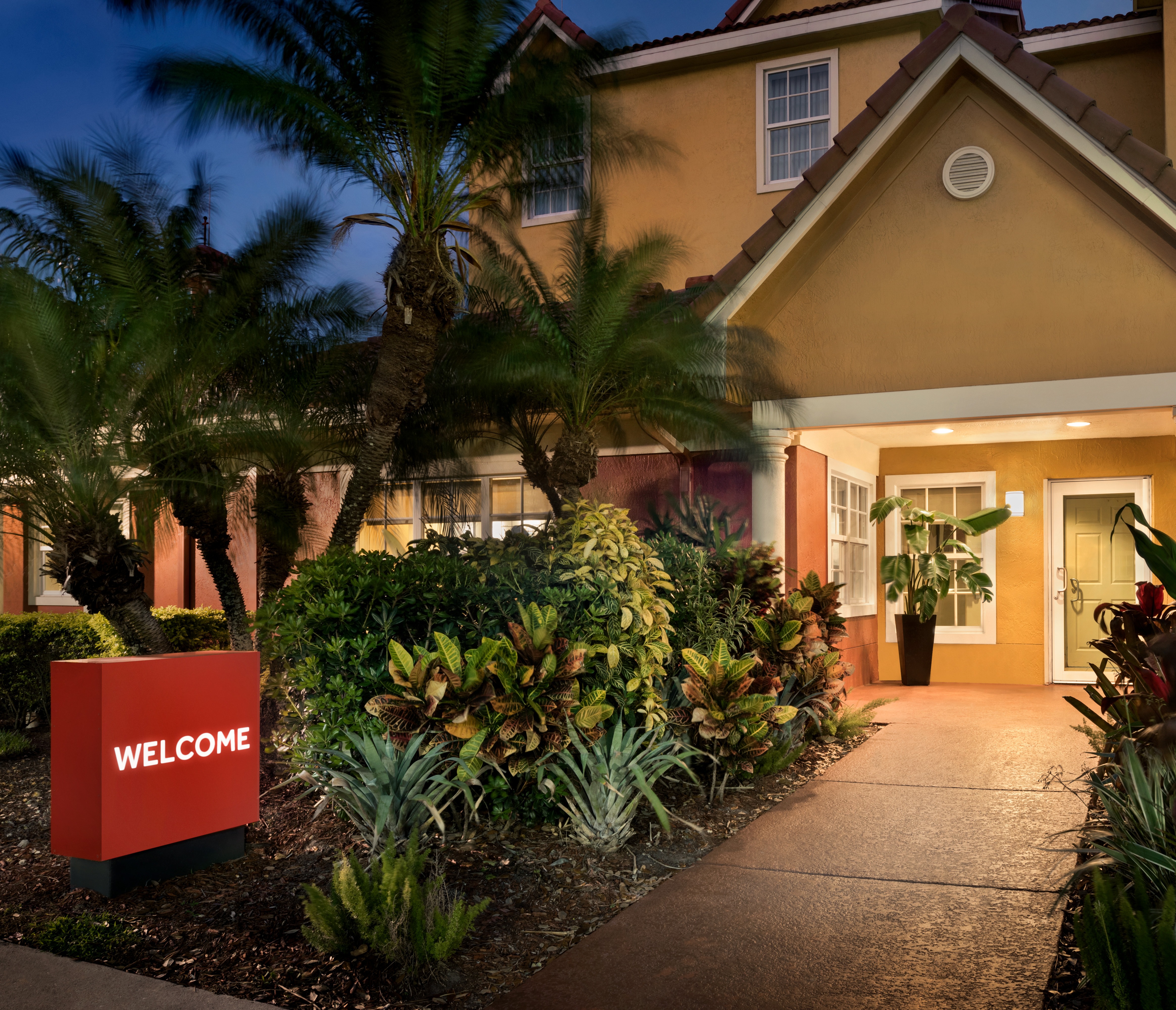 a house with bushes in front of a building