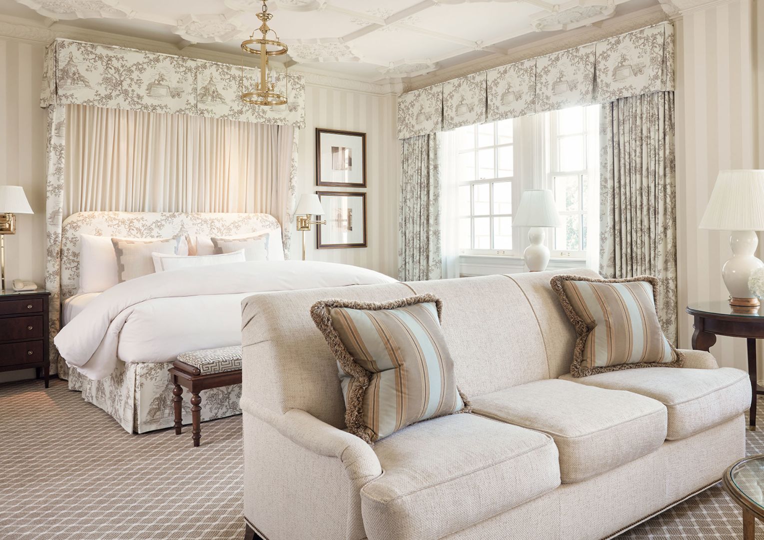 a hotel room filled with furniture and a large window