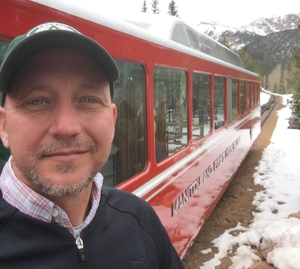 a man in a red train is on the snow