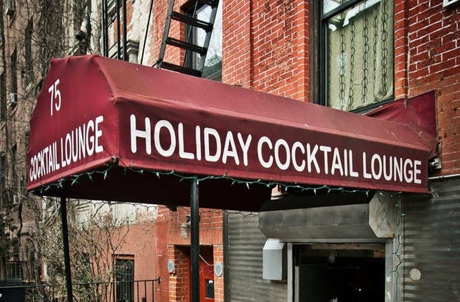 a sign above a store in a brick building