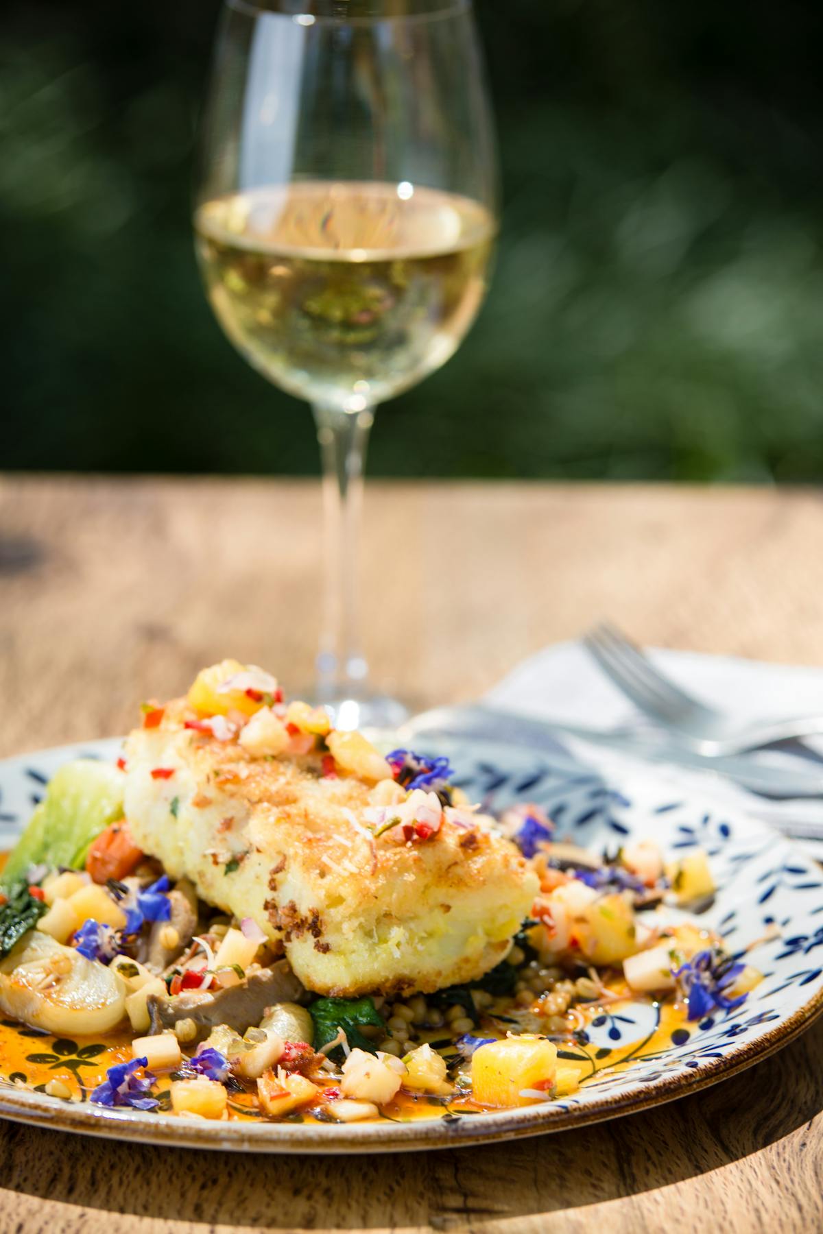 a plate of food and a glass of wine