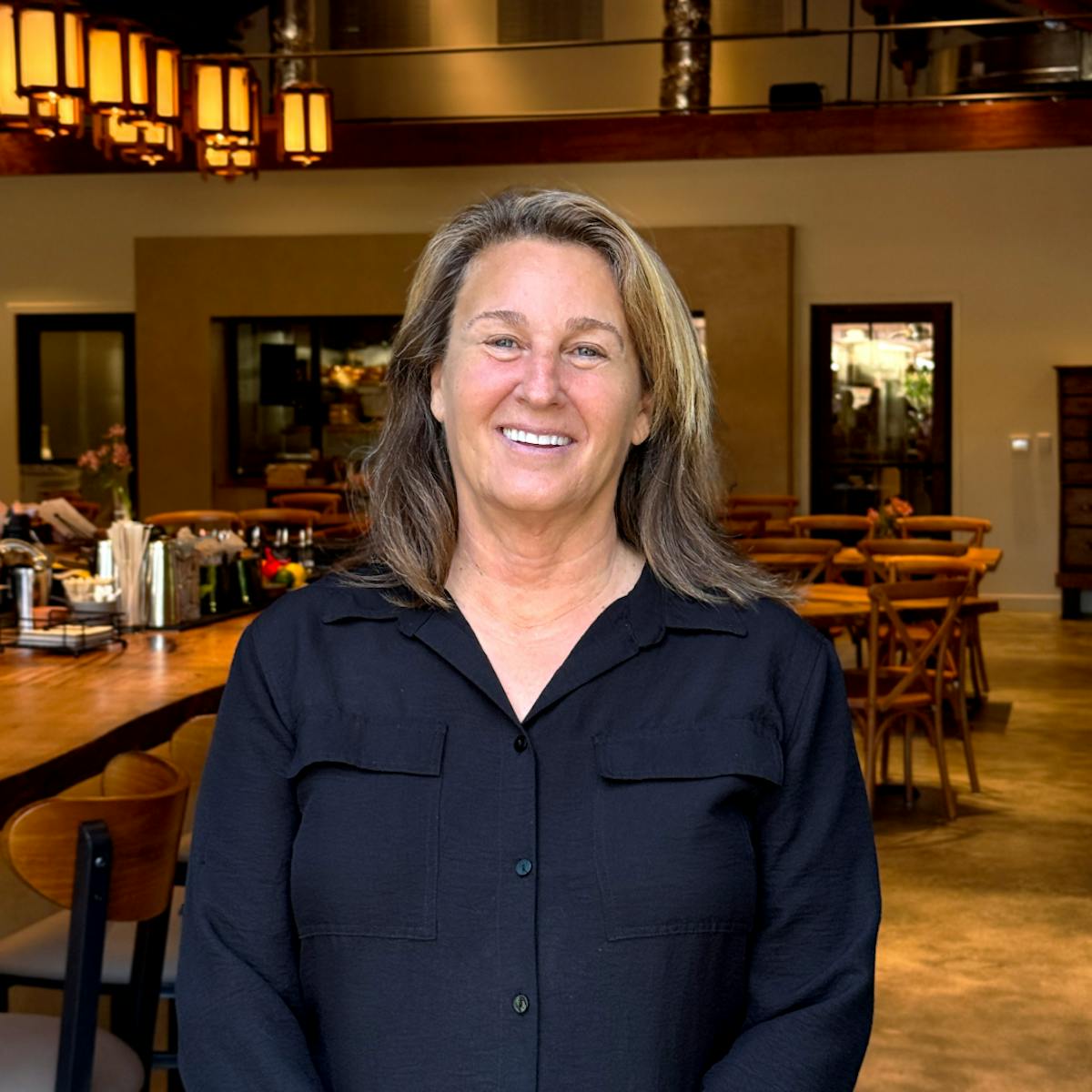 a smiling restaurant manager