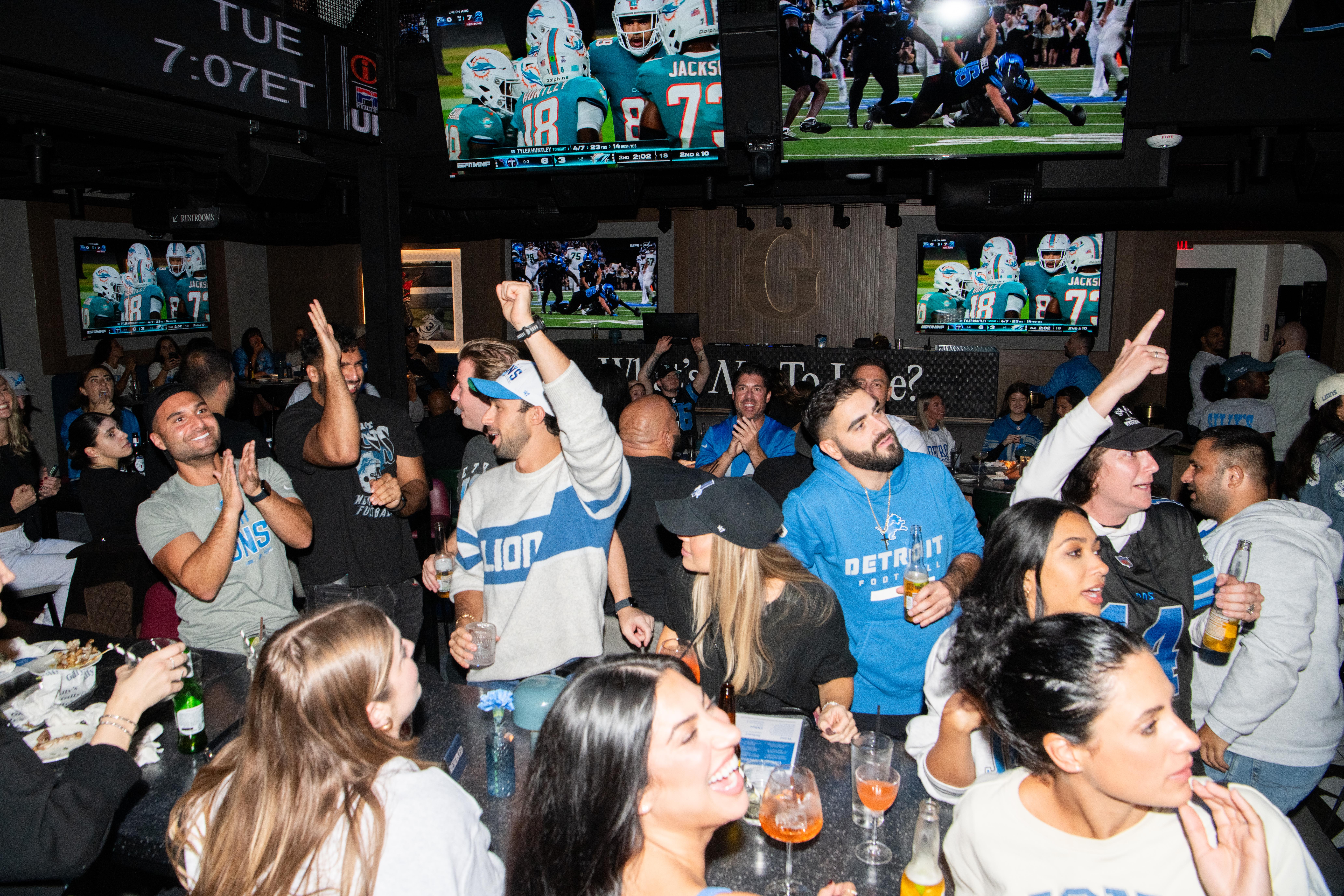 a group of people enjoying the Lions game at Gilly's