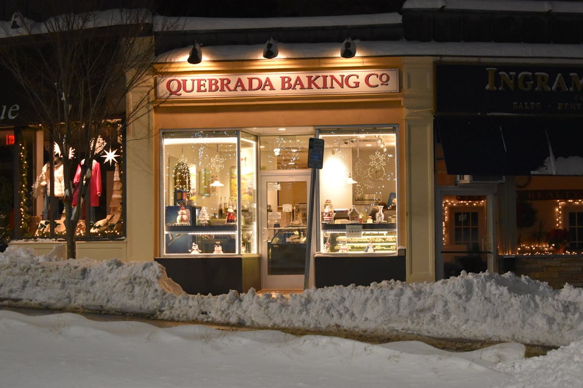 a store front with snow on the ground