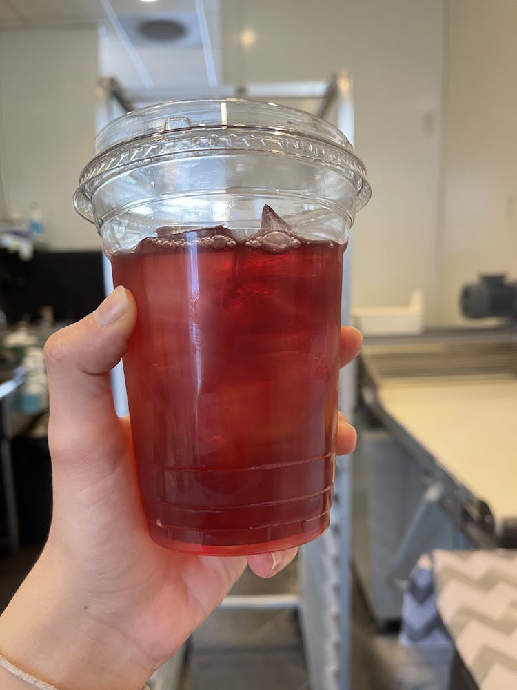 a hand holding a glass of beer