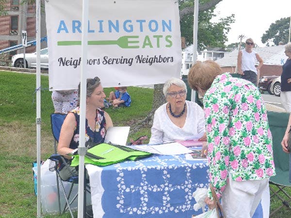 a group of people standing in front of a sign