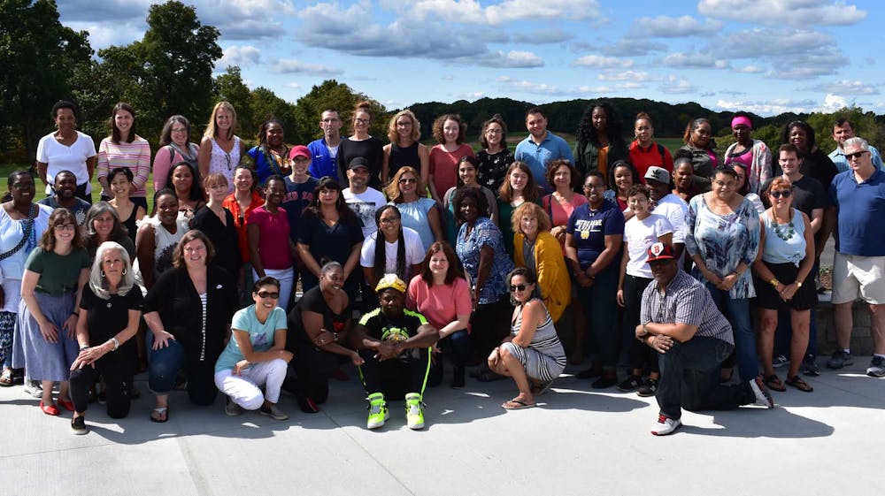 a group of people standing in front of a crowd posing for the camera
