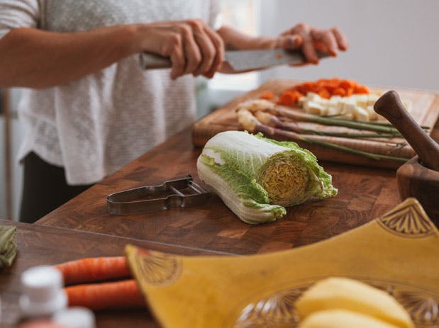 a person cutting food on a table