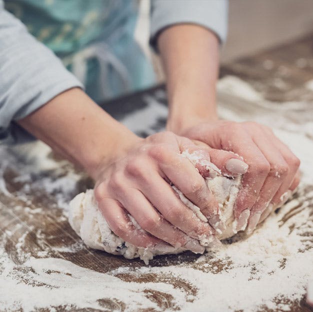 a person cutting a piece of cake on a plate