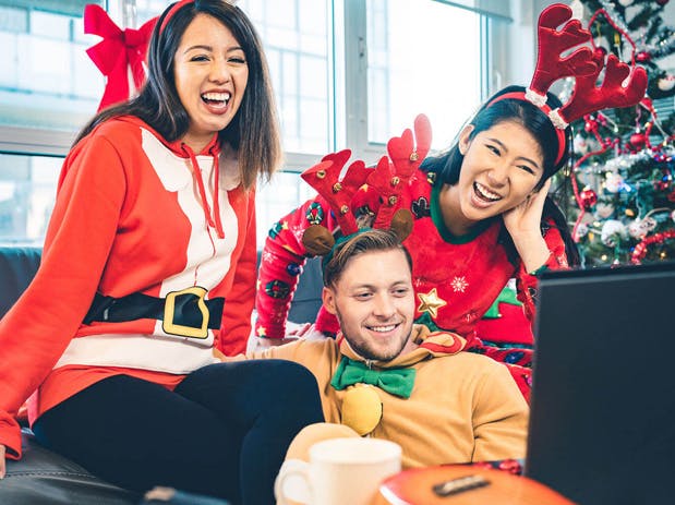 a group of young children sitting next to a laptop