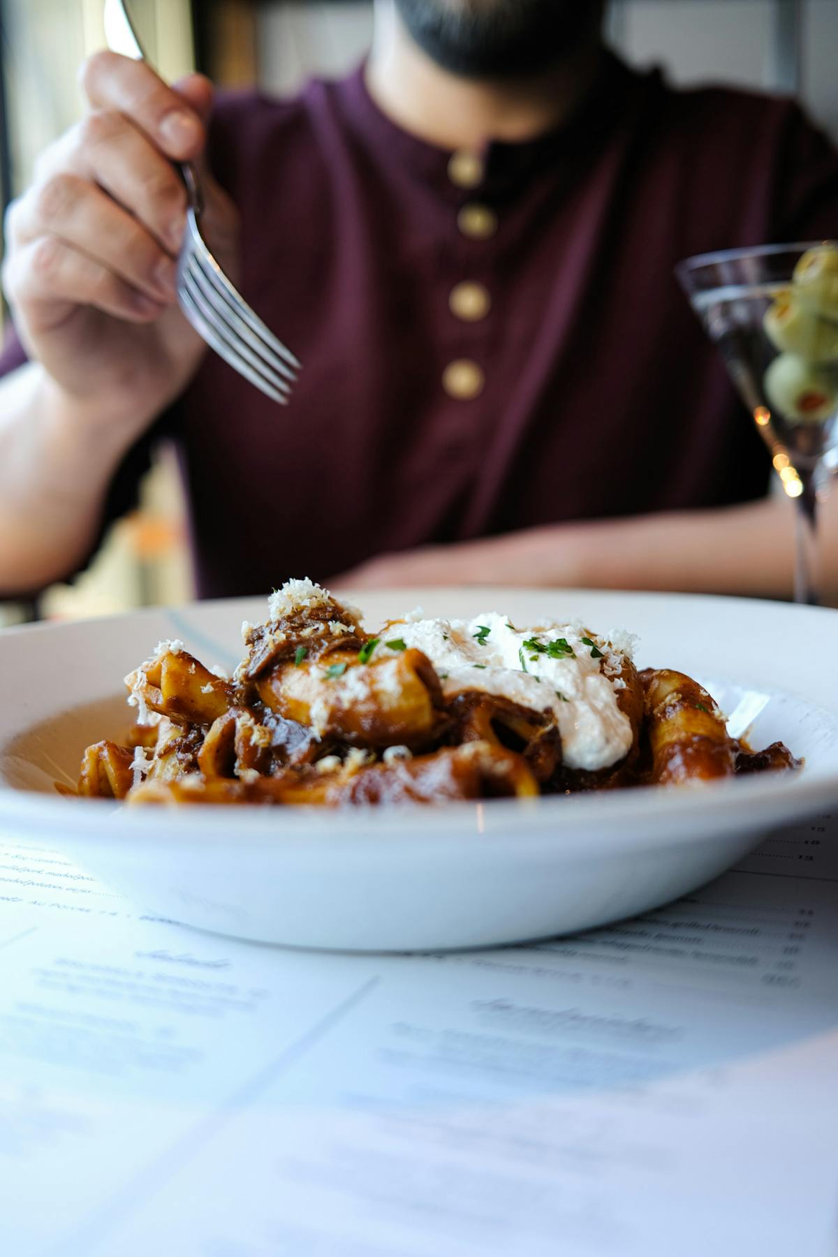 a person sitting at a table in front of a plate of food